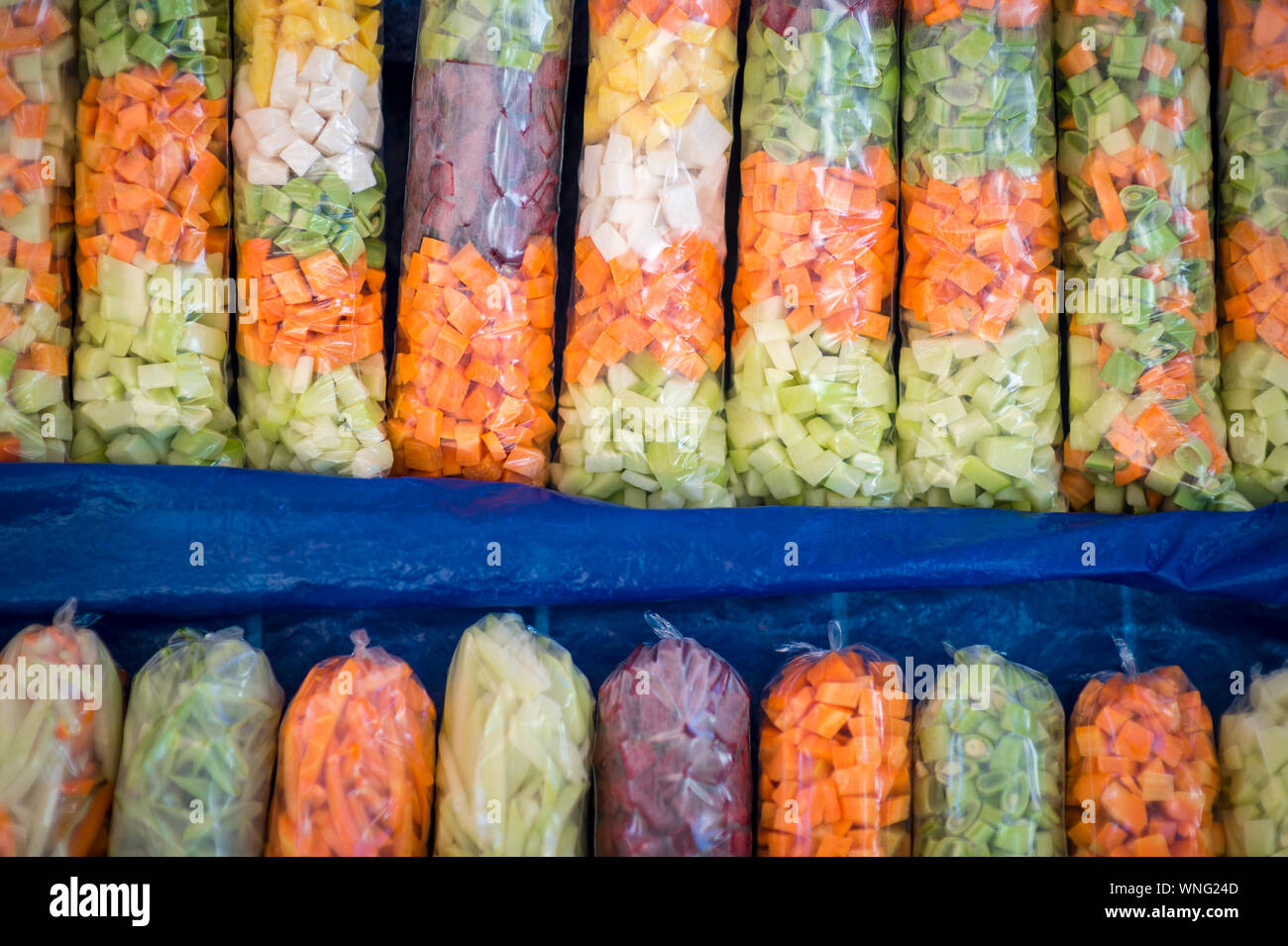Full frame close-up of colorful sacks of fresh grated vegetables on display at a farmers market in Rio de Janeiro, Brazil Stock Photo