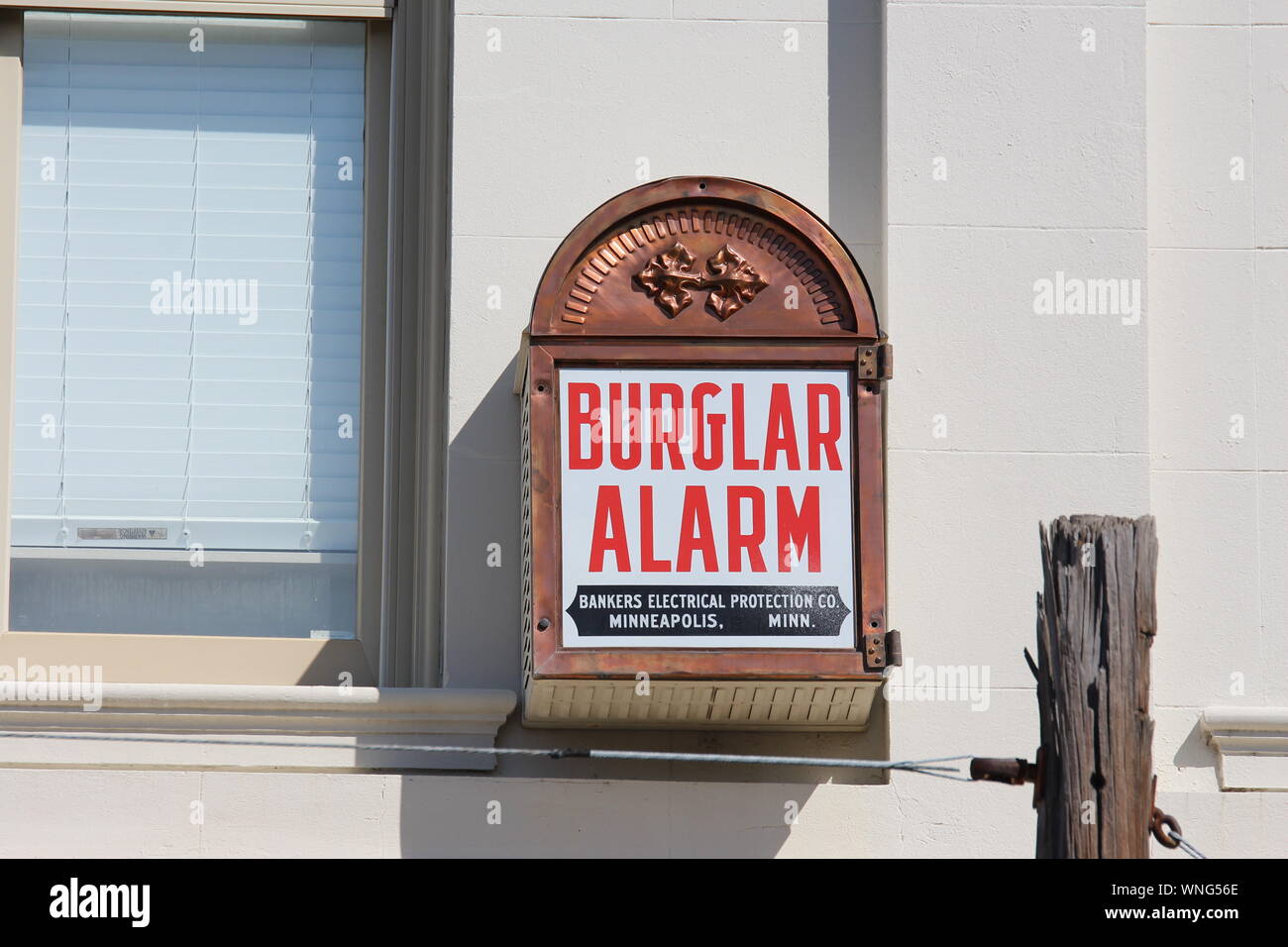 Antique burglar alarm next to window on side of building Stock Photo - Alamy