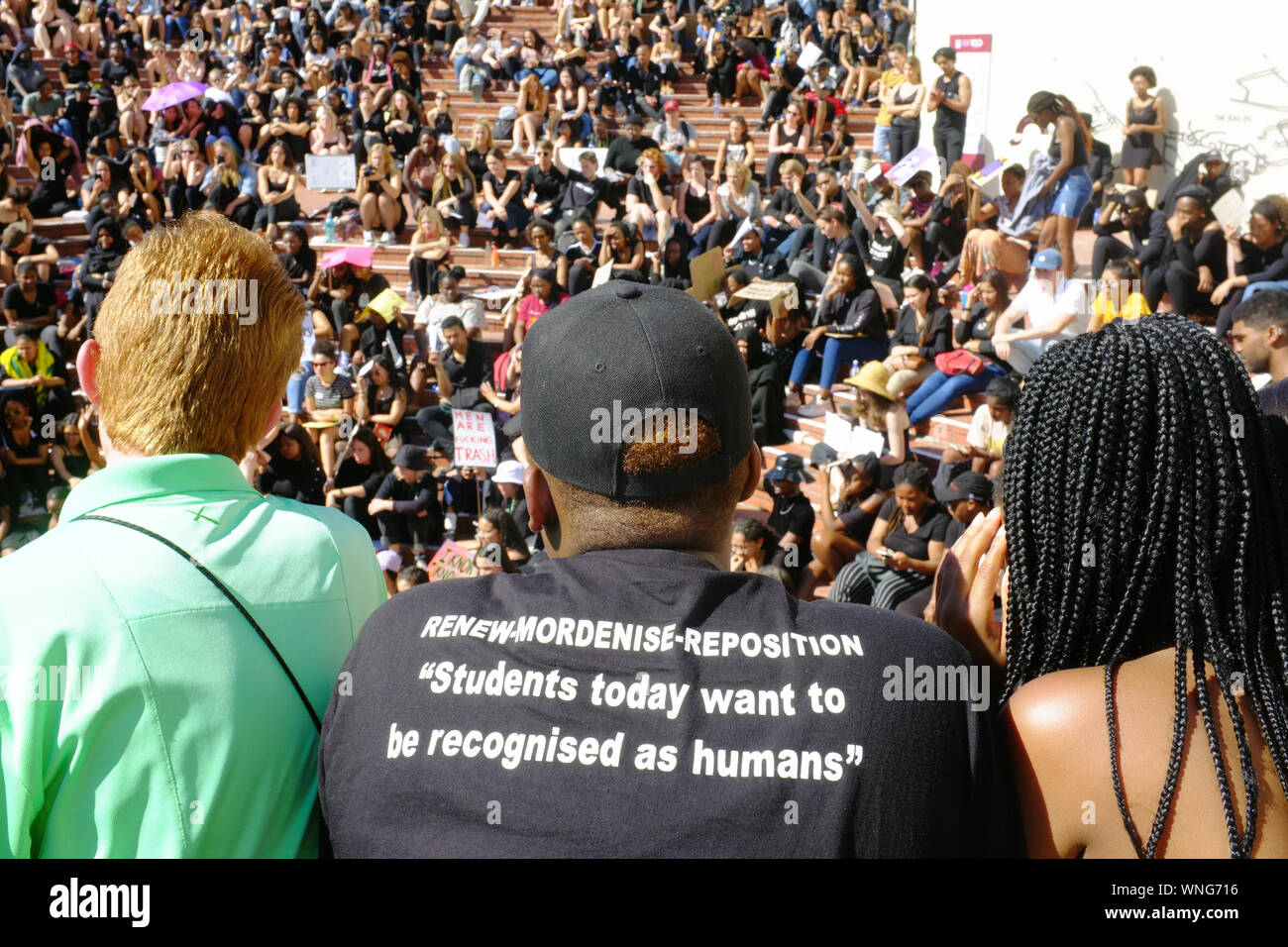 Students from the University of Stellenbosch dressed in black gather to protest against the recent events of gender violence that have rocked South Africa. Several hundred students and staff members held a 2 hour protest at the university demanding action from senior staff members. The protesters come after a series of high profile murders and rapes have shaken South Africa and resulted in calls for action and a national shut down. Stock Photo