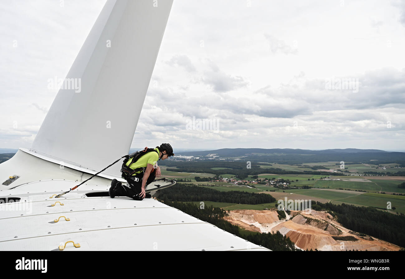 Gebenbach, Germany. 06th Sep, 2019. Franz Schlecht, technical operator for renewable energies, looks down from the 140-metre-high wind turbine. The Bavarian Minister of Economic Affairs Aiwanger (Free Voters) visited the wind turbine of the Gebenbach citizen energy park. Credit: Nicolas Armer/dpa/Alamy Live News Stock Photo