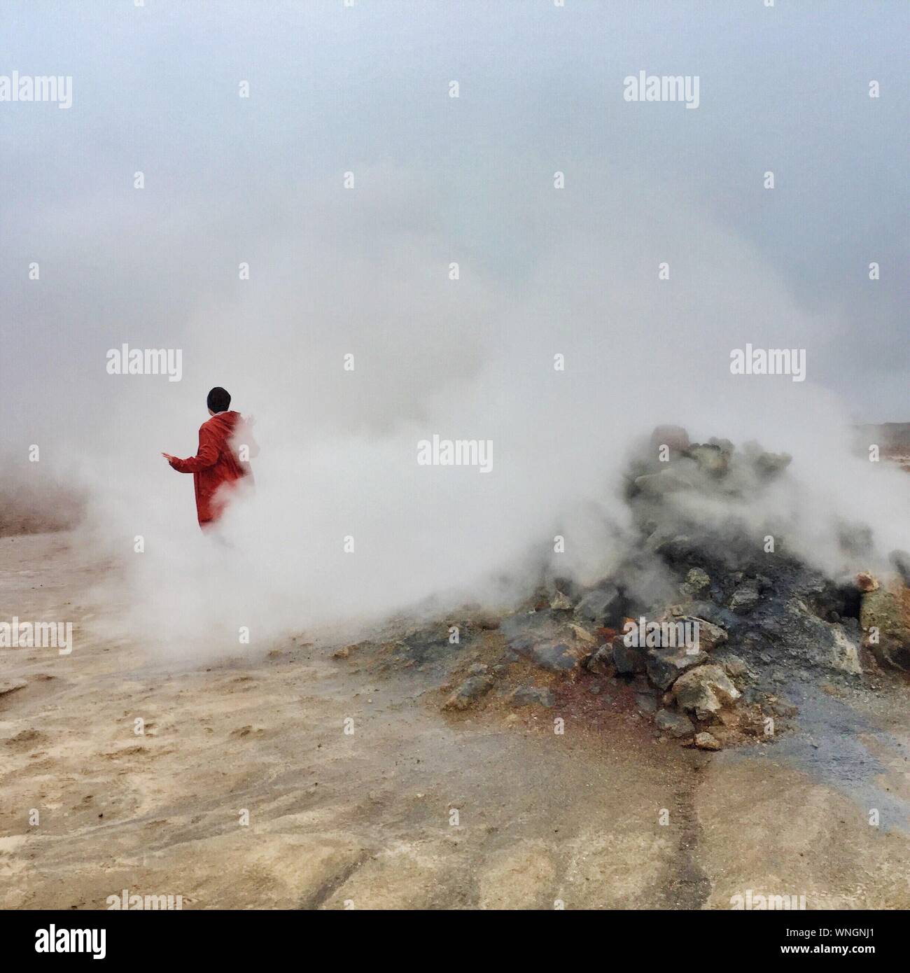 Rear View Of Person Standing By Hot Spring Stock Photo
