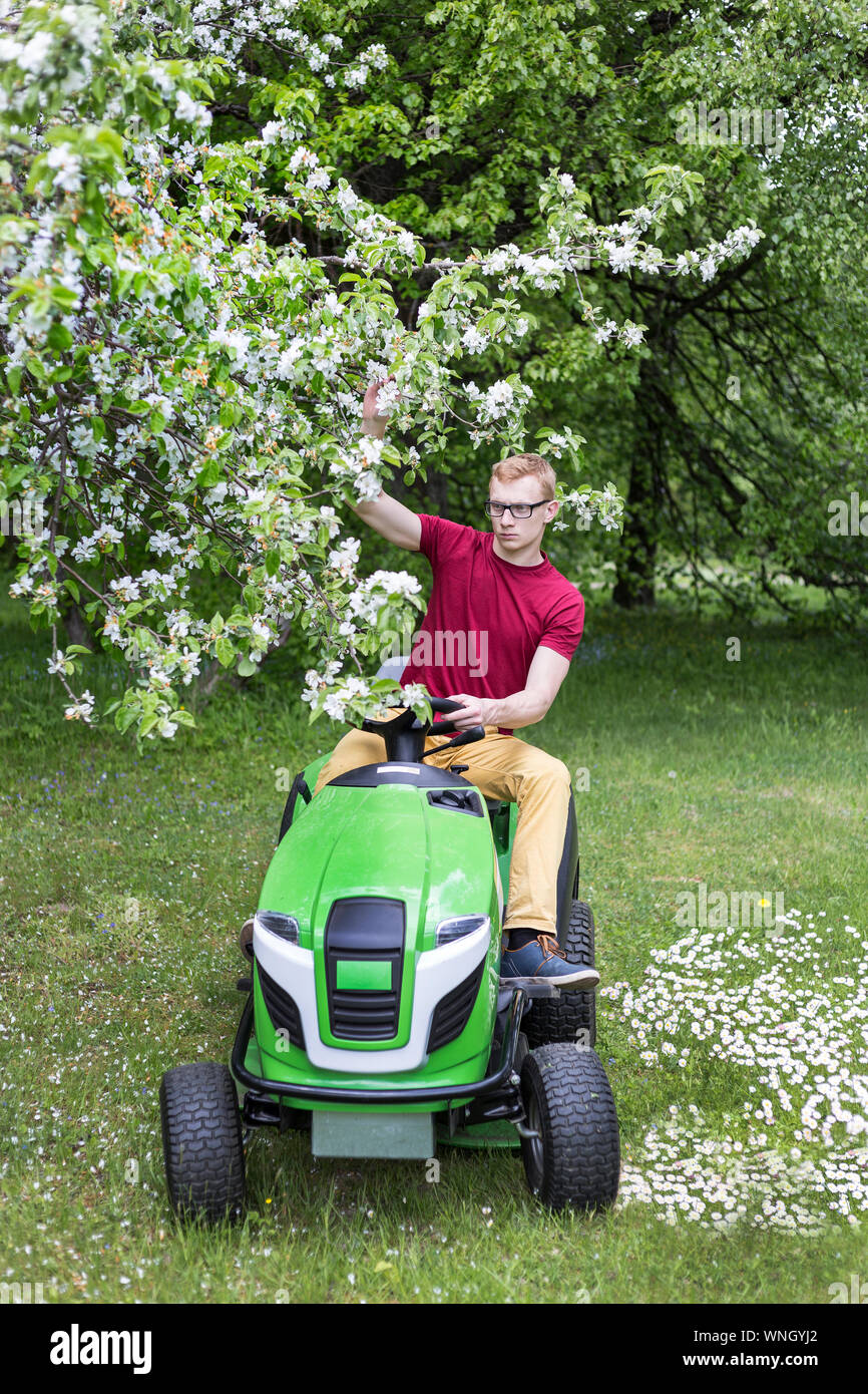 Man sitting on lawn mower hires stock photography and images Alamy