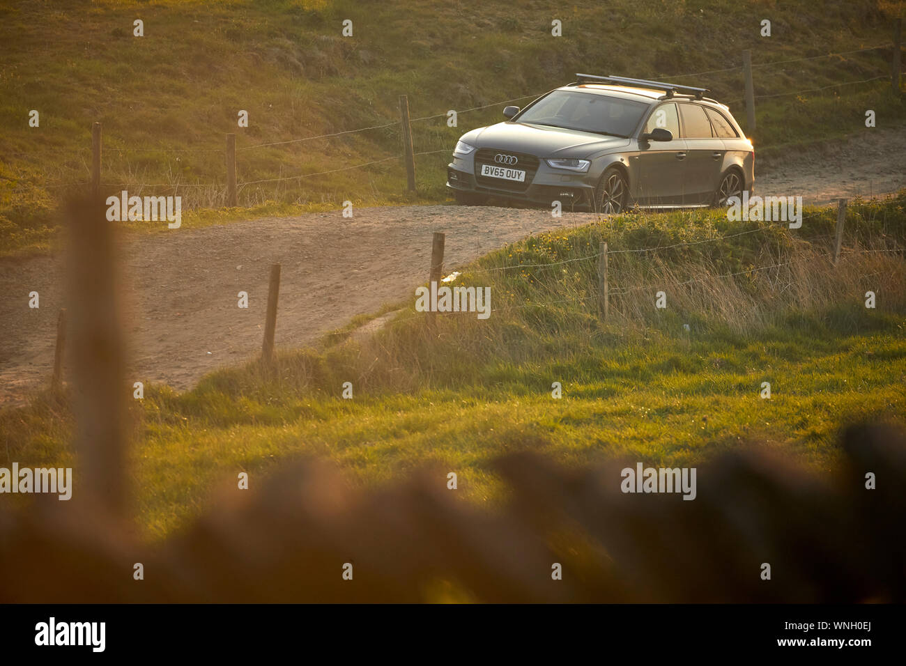 Grey Audi  on a country road dirt track in the countryside on Hartshead pike hill Stock Photo