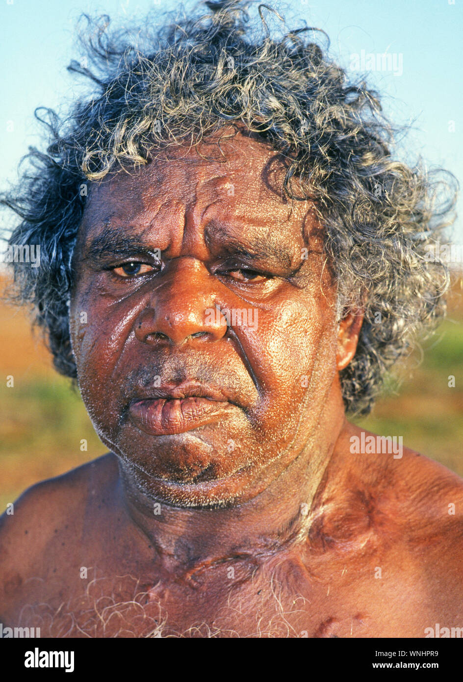 An Australian Aborigine hunter in the Outback near Ayers Rock or Uluru National Park,  in the Northern Territory of Australia. Stock Photo