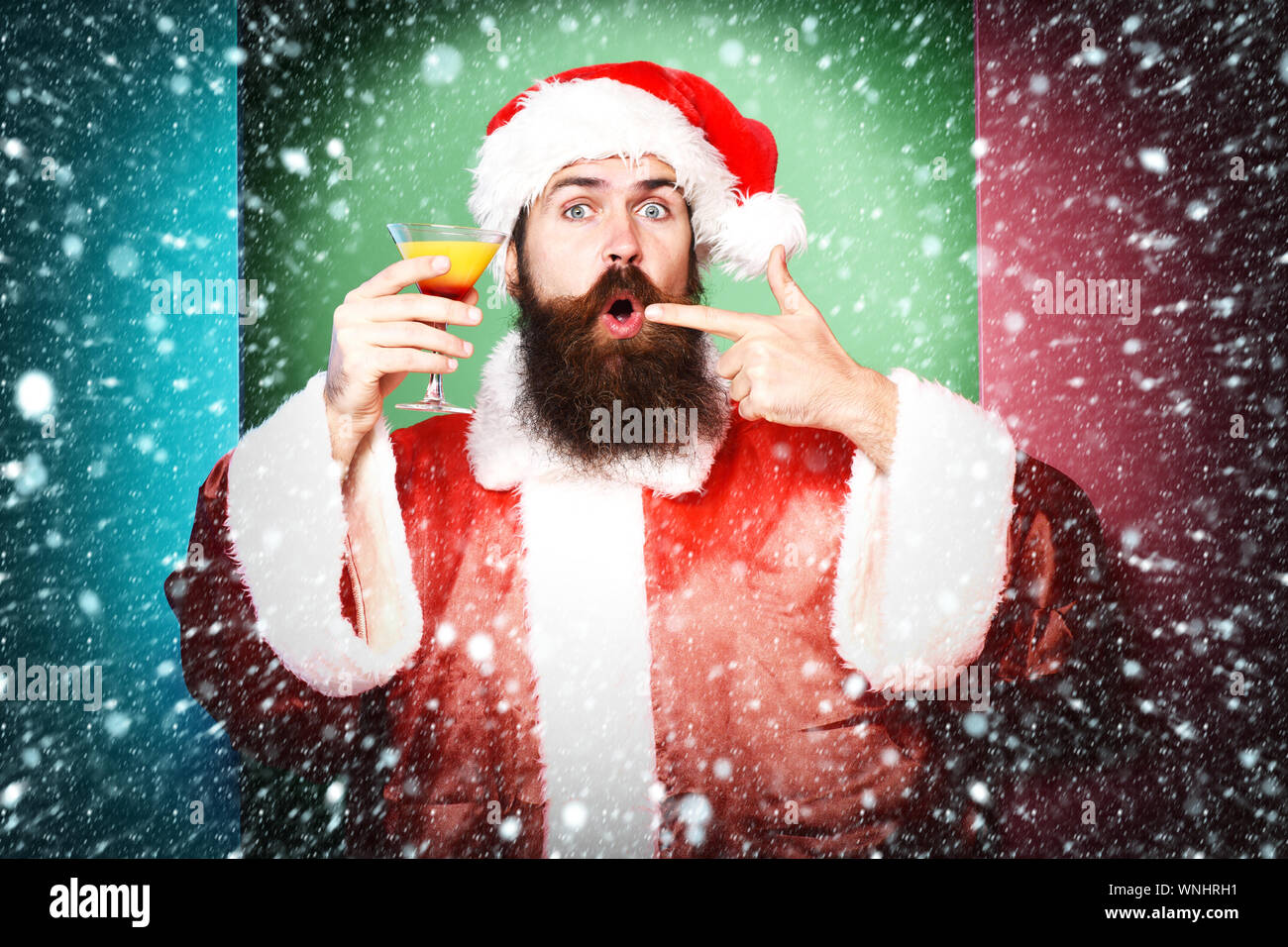 handsome bearded santa claus man with long beard on funny face holding ...