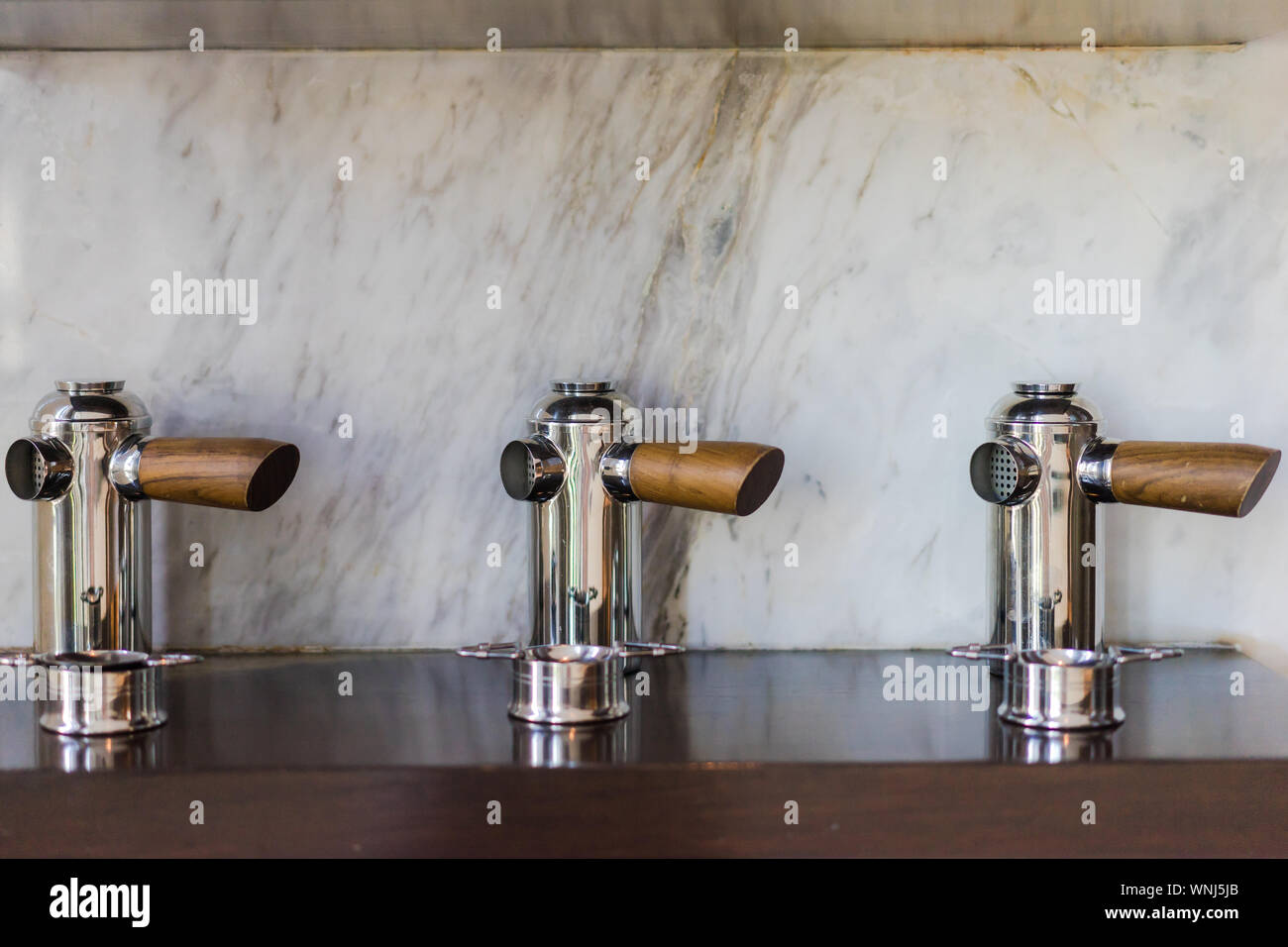 Close-up Of Taps Against Wall Stock Photo