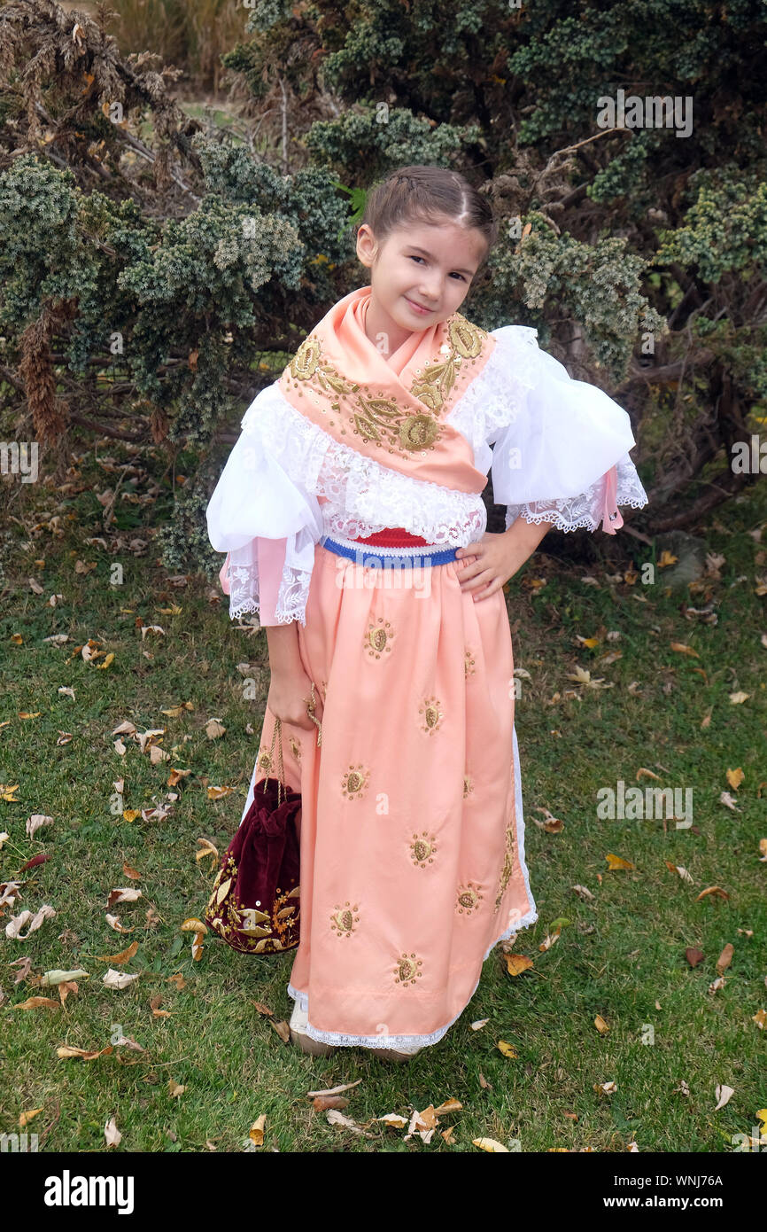 Girl dressed in folk costumes go to the church at the Mass on Thanksgiving day in Stitar, Croatia Stock Photo