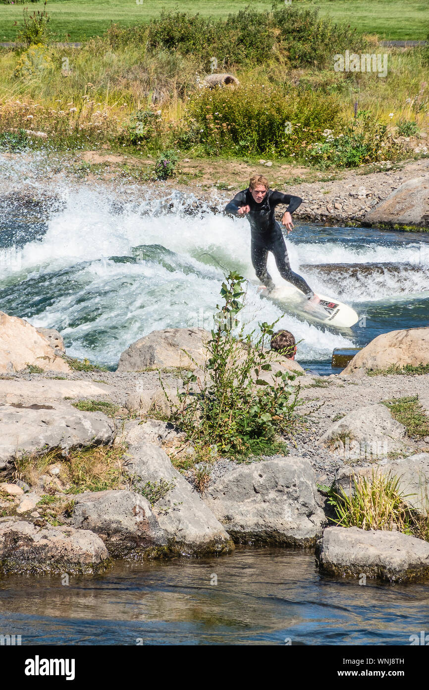 River surfing on the Deschutes River in Bend, Oregon. River surfing is