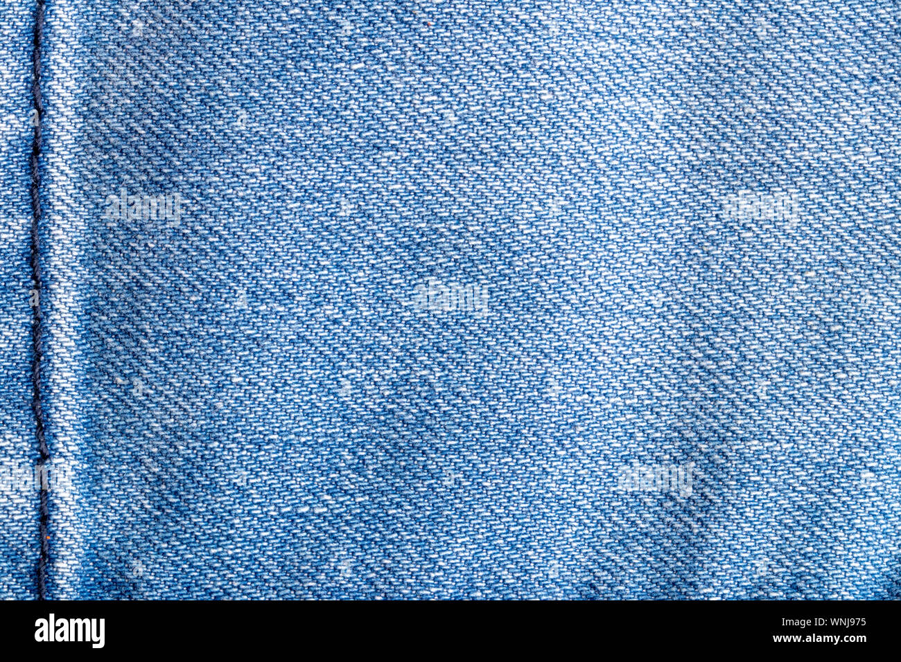 Denim Background Texture Close Up Of Details Of Empty Light Blue Jeans Fabric Jean Surface With Dark Blue Vertical Seam On Left Side Macro Top Vie Stock Photo Alamy