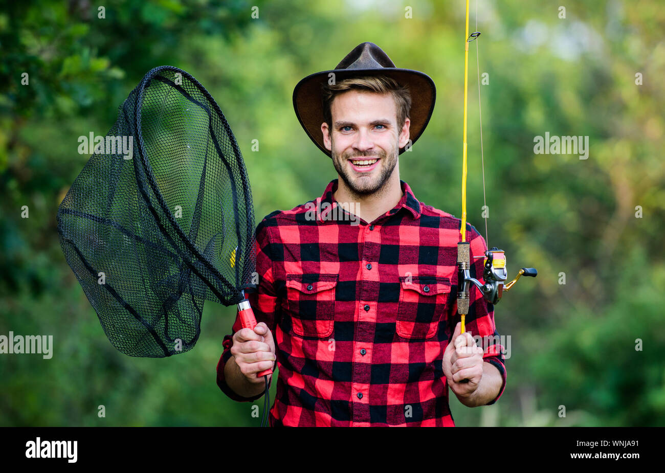 https://c8.alamy.com/comp/WNJA91/fishing-in-my-hobby-handsome-guy-in-checkered-shirt-with-fishing-equipment-nature-background-summer-weekend-concept-hipster-fisherman-with-rod-spinning-net-hope-for-nice-fishing-fishing-day-WNJA91.jpg