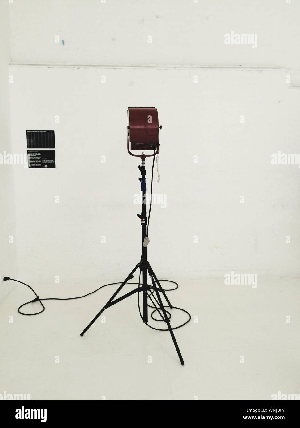 Close-up Of Microphone Stand Against White Wall Stock Photo