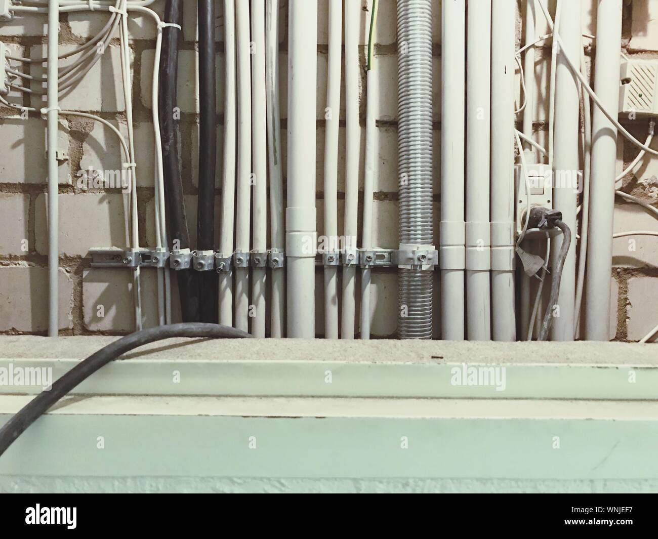 Electric Cables And Pipes On Wall Stock Photo Alamy