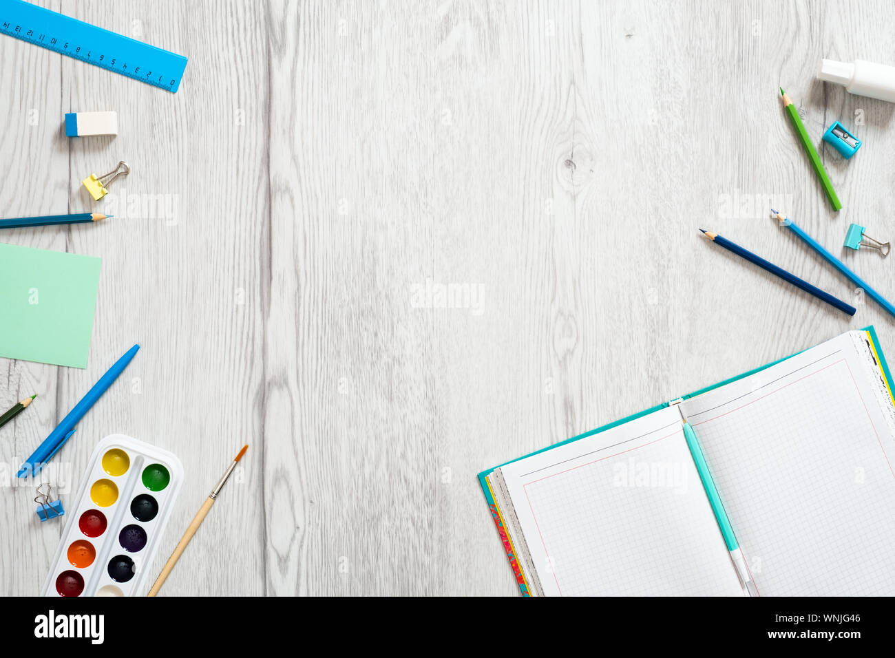 School notebook and various stationery on wooden background. Back to school  concept. Flat lay, top view, overhead Stock Photo - Alamy