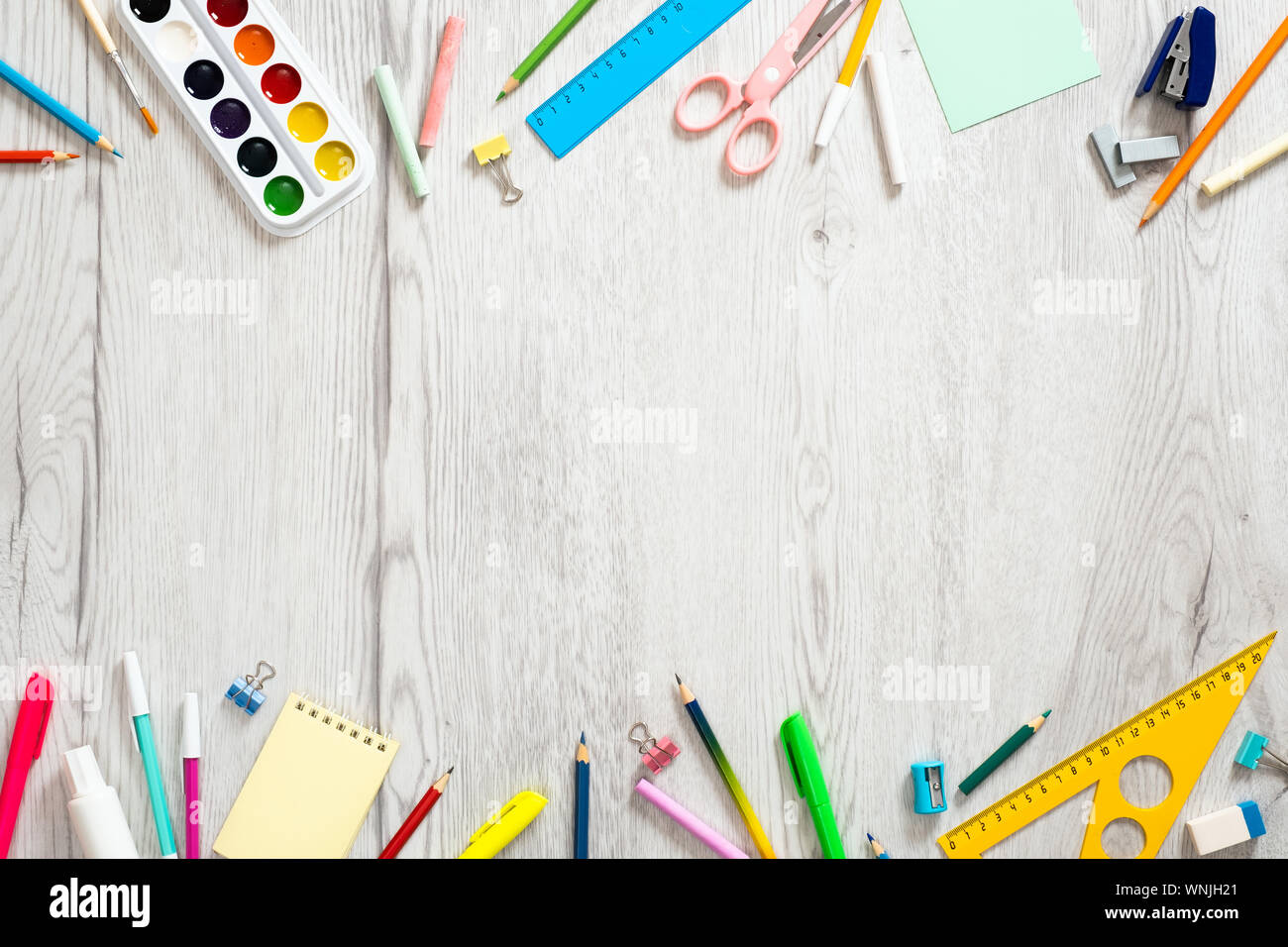 https://c8.alamy.com/comp/WNJH21/back-to-school-concept-creative-layout-with-with-various-school-supplies-and-stationery-on-wooden-desk-table-flat-lay-design-top-view-overhead-WNJH21.jpg