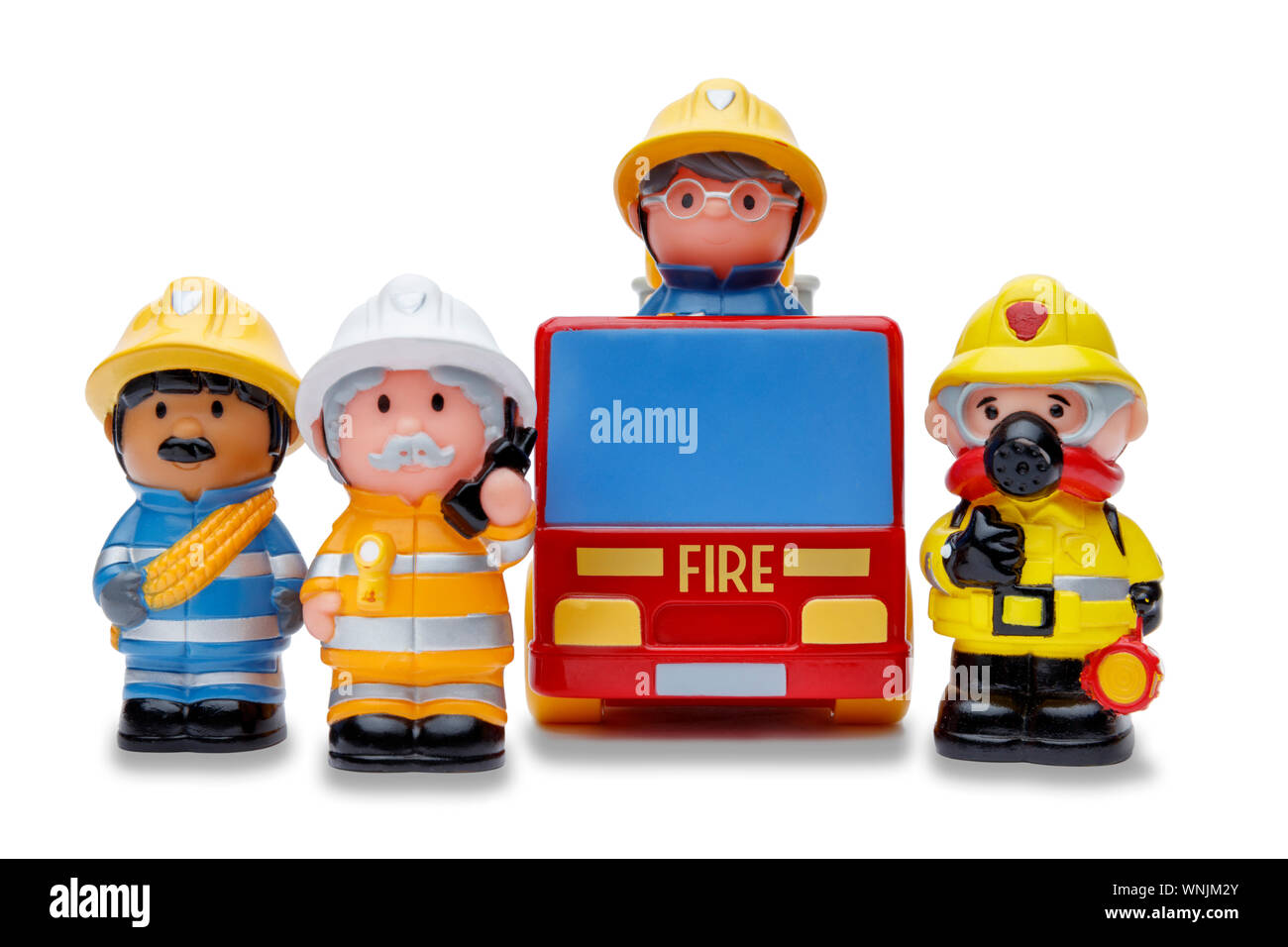 A line of 3 toy firefighters standing to attention, and a fire engine, shot on a white background Stock Photo