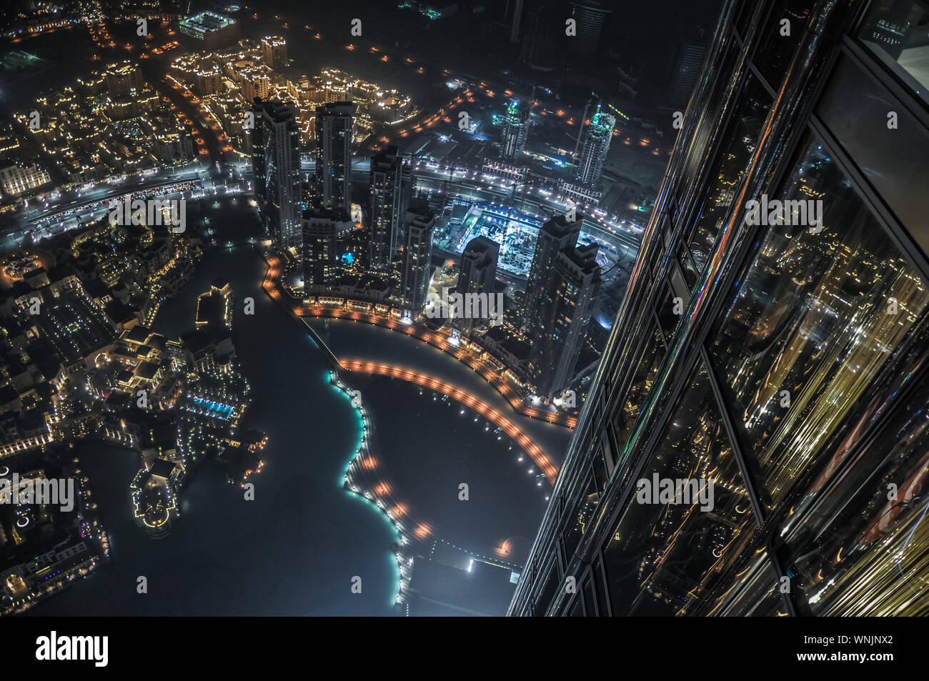 Illuminated Modern Cityscape Seen From Burj Khalifa At Night Stock Photo