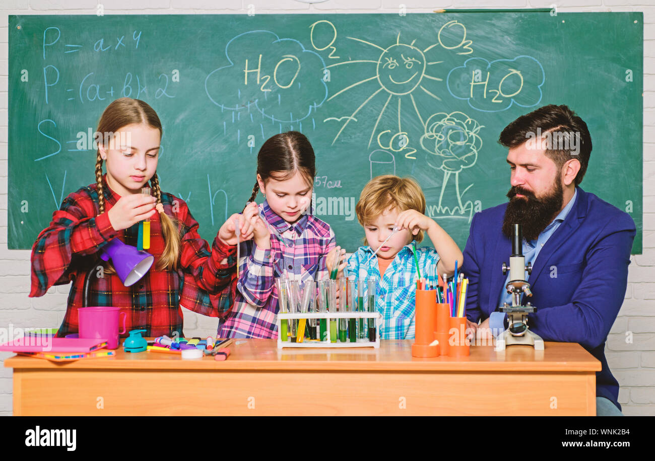 kids in lab coat learning chemistry in school laboratory. chemistry lab. happy children teacher. back to school. making experiment in lab or chemical cabinet. Research and development. Stock Photo