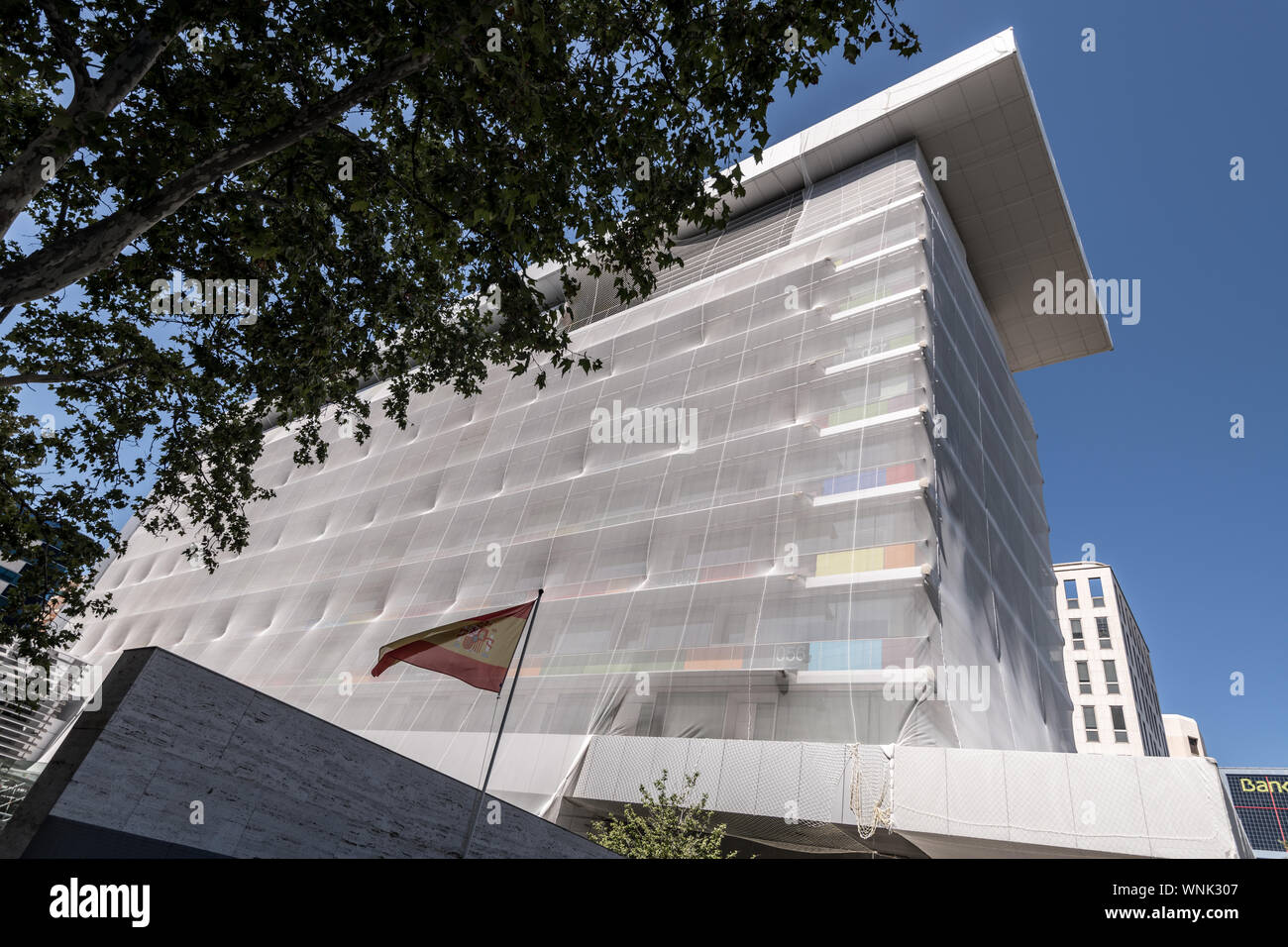 Modern building wrapped in scaffolding and protective sheeting, Castellana, Madrid Spain Stock Photo