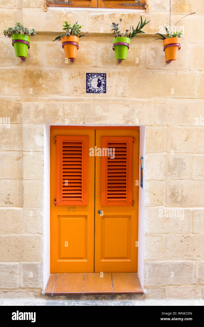 Typical, coloured front door of a residential house, in the alleys of