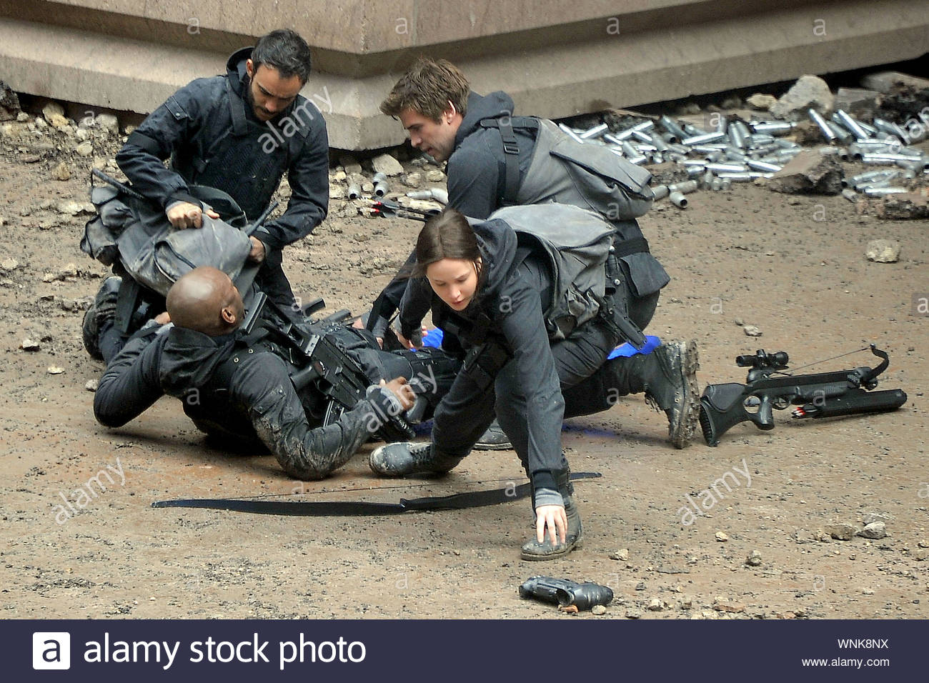 Noisy Le Grand France Jennifer Lawrence And Liam Hemsworth Run To Aid A Wounded Member Of Their Group While Filming Scenes For Their Upcoming The Hunger Games Mockingjay In France The Group Gathered