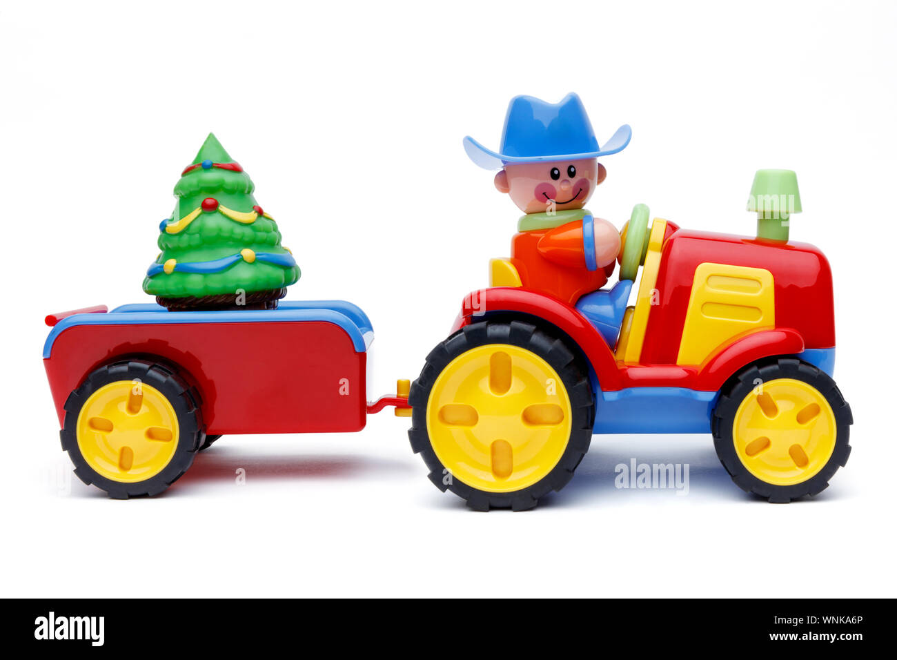 Side on shot of a Farmer Christmas and his tractor, pulling a trailer  carrying a christmas tree, isolated and shot on a white background Stock  Photo - Alamy