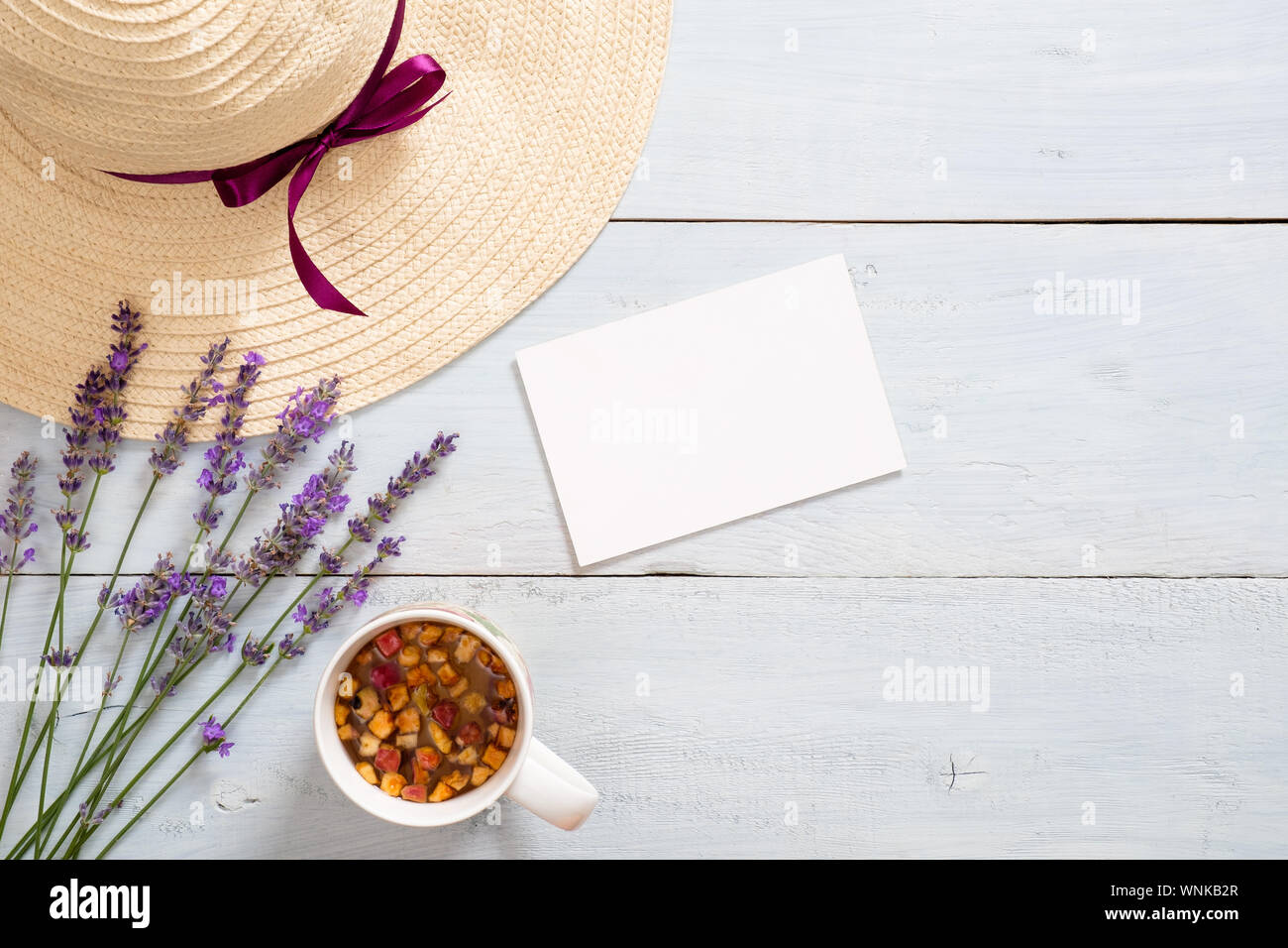 Flatlay feminine desk with straw hat 
