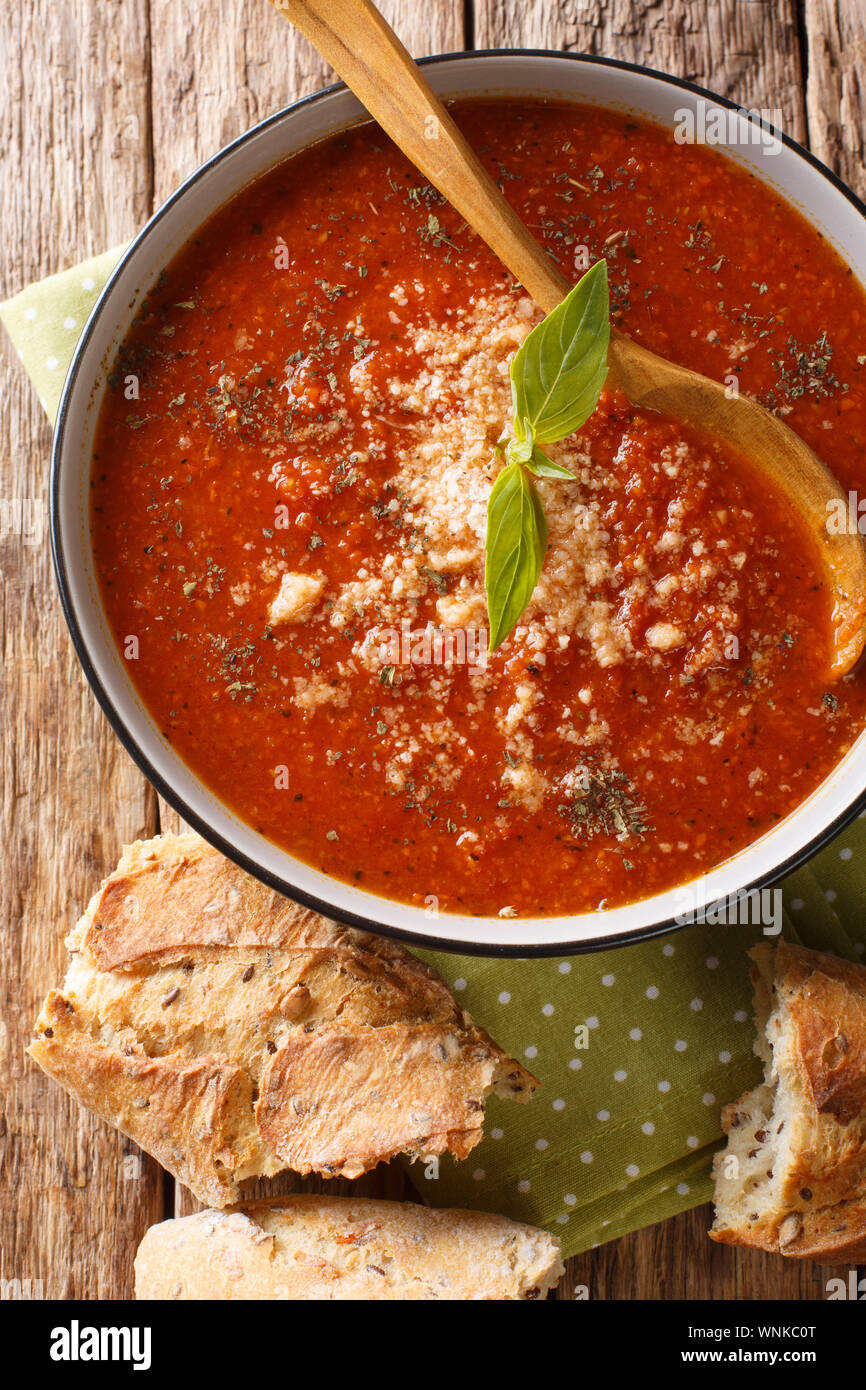 Tasty Tomato Basil Soup With Parmesan Close Up In A Bowl With Bread On The Table Vertical Top View From Above Stock Photo Alamy