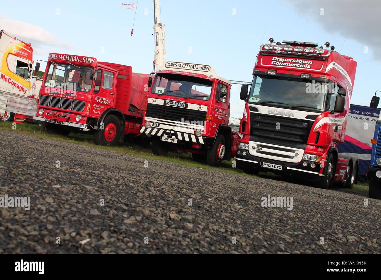 Row of red lorries: Leyland Beaver and Scania 81 (both bearing the name James McGeehan) and a Scania R500 V8 owned by Draperstown Commercials Stock Photo