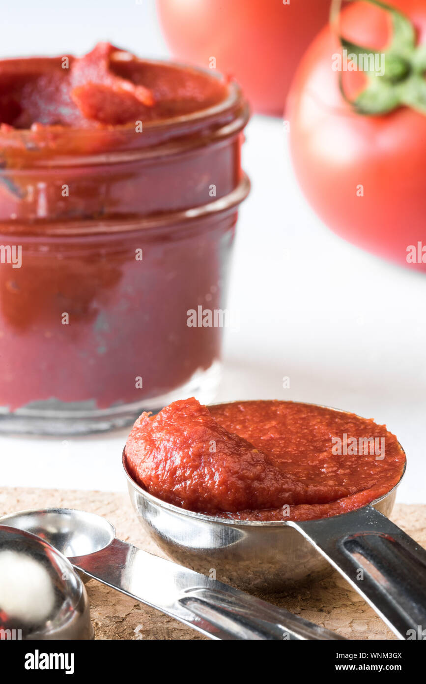 Close-up Of Tomato Paste In Steel Spoon Stock Photo
