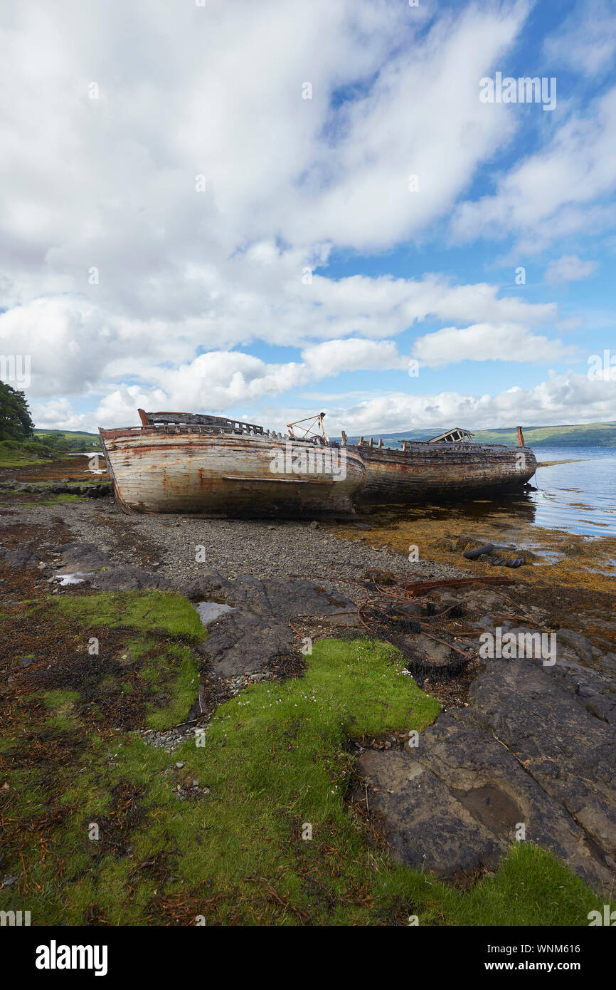 Two abandoned fishing boats on the shore of Salen Bay, Isle of Mull, Scotland, UK. Ship wrecks Stock Photo