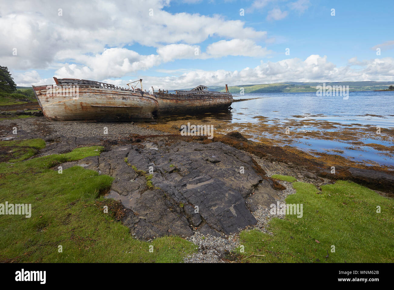 Two abandoned fishing boats on the shore of Salen Bay, Isle of Mull, Scotland, UK. Ship wrecks Stock Photo