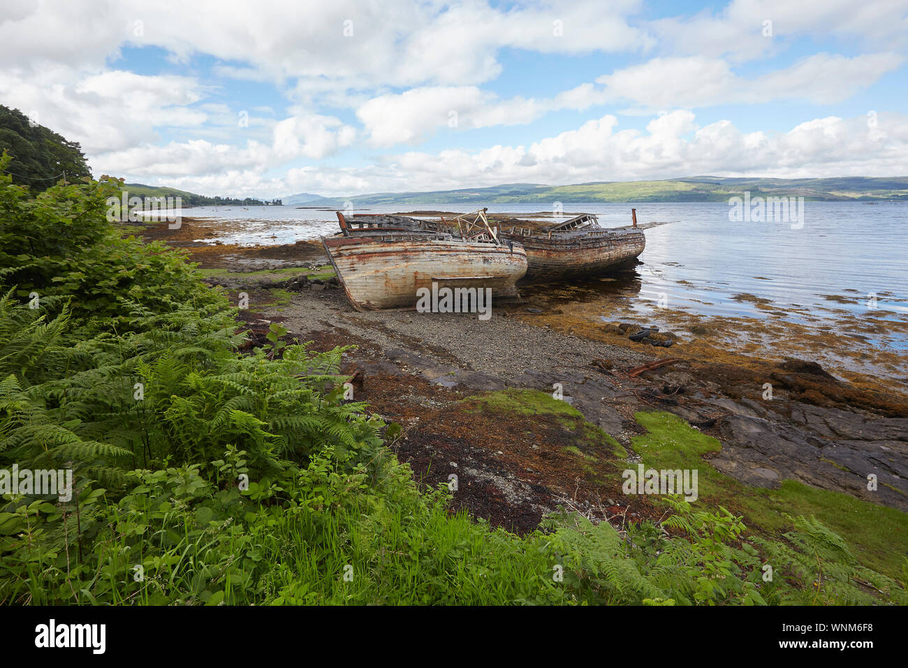 Two abandoned fishing boats on the shore of Salen Bay, Isle of Mull, Scotland, UK. Ship wrecks Stock Photo