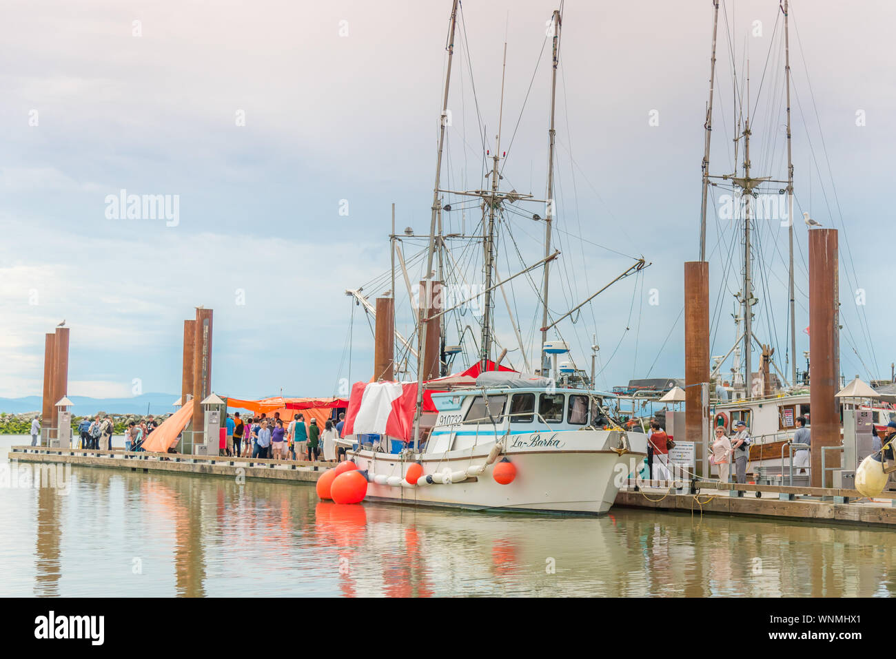 Steveston, British Columbia/Canada - June 24, 2018: people shopping for freshly caught seafood from boats docked at Fisherman's Wharf Stock Photo