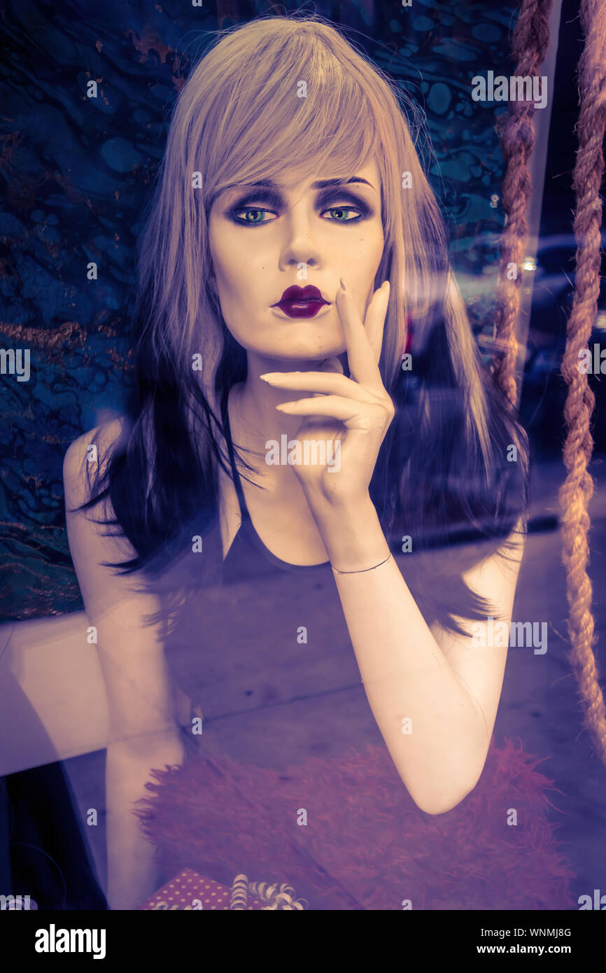 Cool and stylish looking female mannequin in a store window Stock Photo