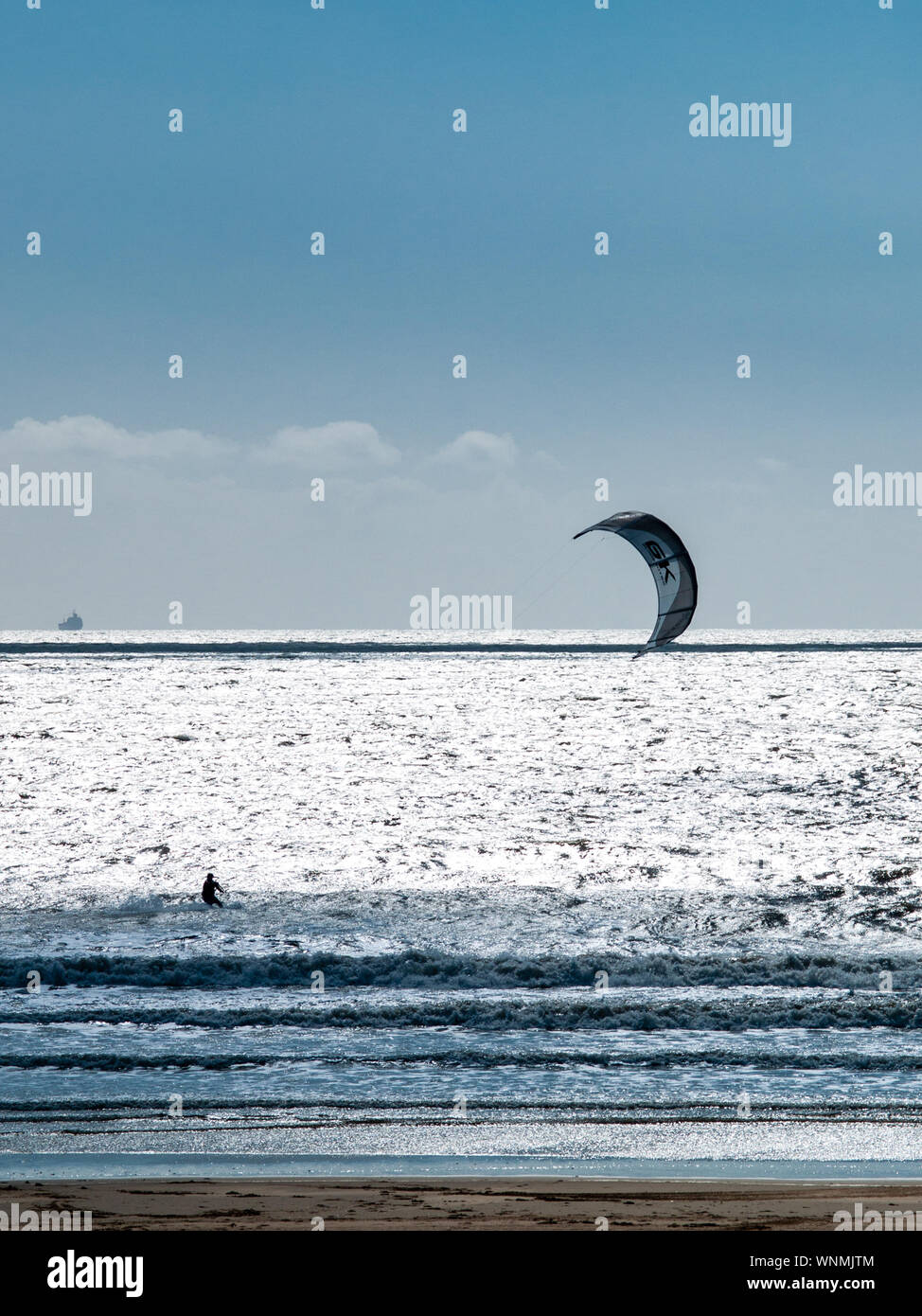 Kitesurfer silhouetted against bright seascape at Aberavon Beach, Port Talbot, Swansea bay, Wales, UK. Stock Photo
