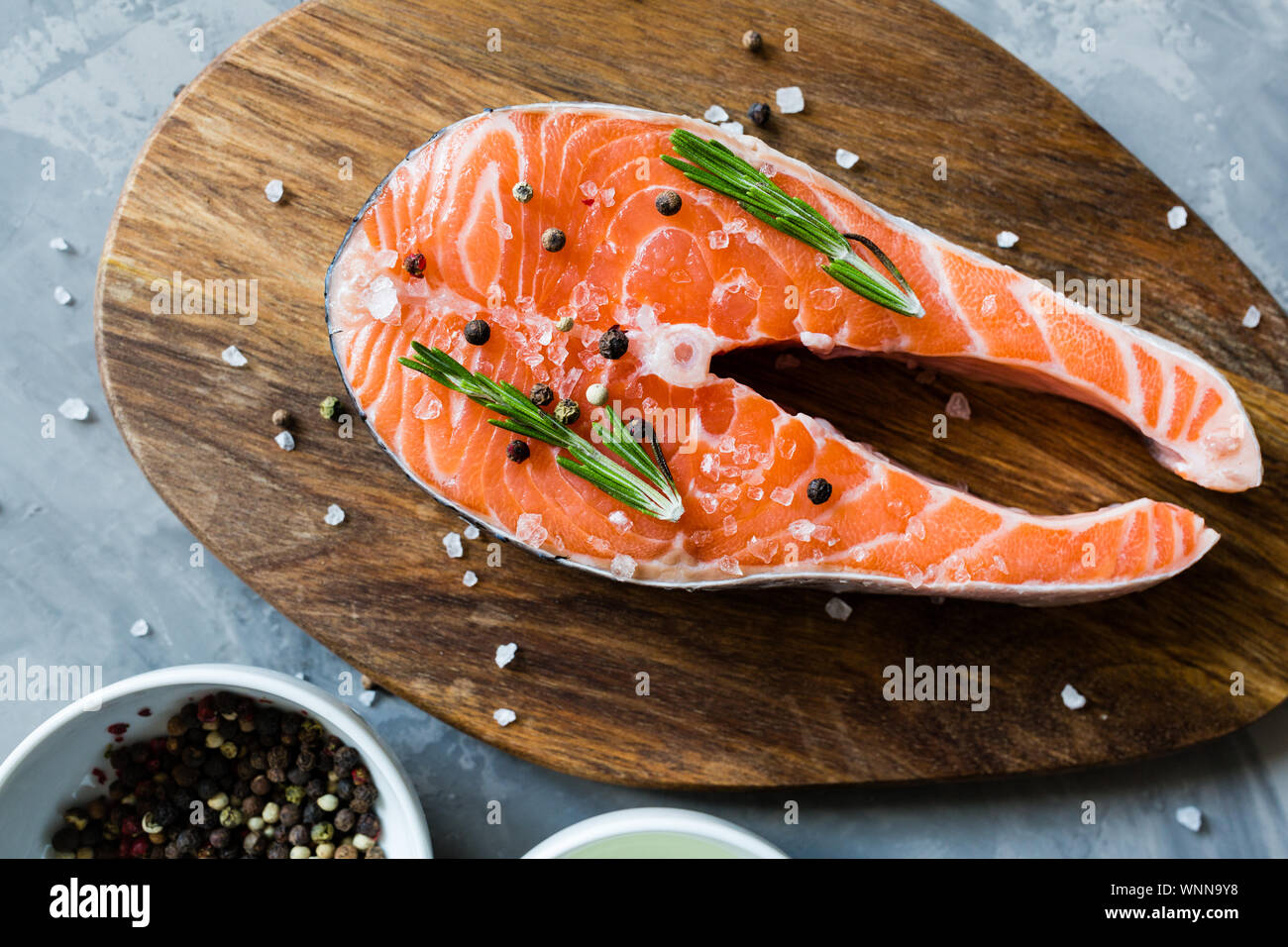 Fresh raw salmon fish steak with spices on dark stone background ...