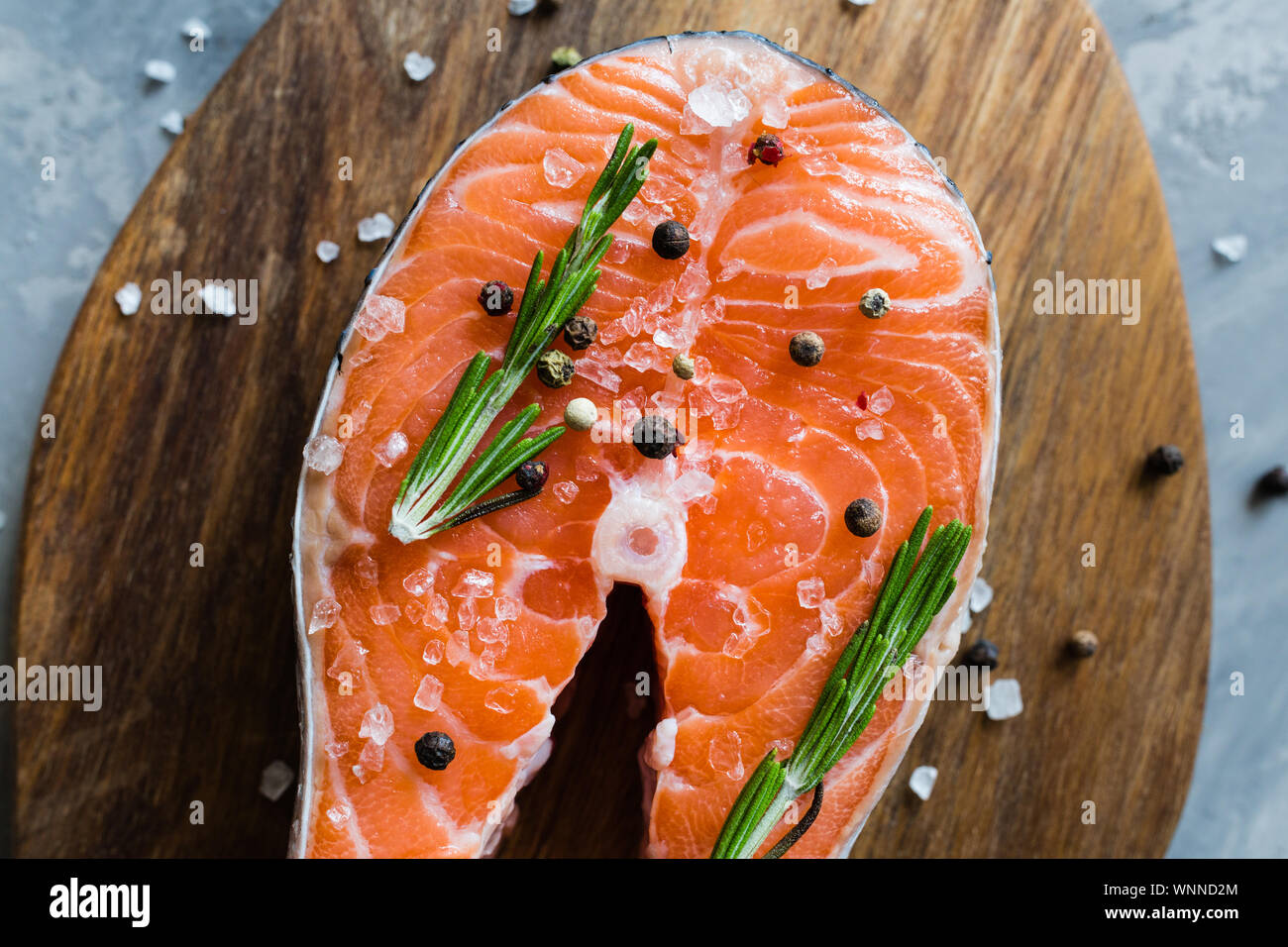 Fresh raw salmon fish steak with spices on dark stone background ...