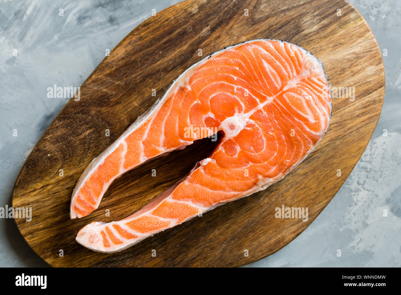 Fresh raw salmon fish steak on dark stone background. Creative layout ...