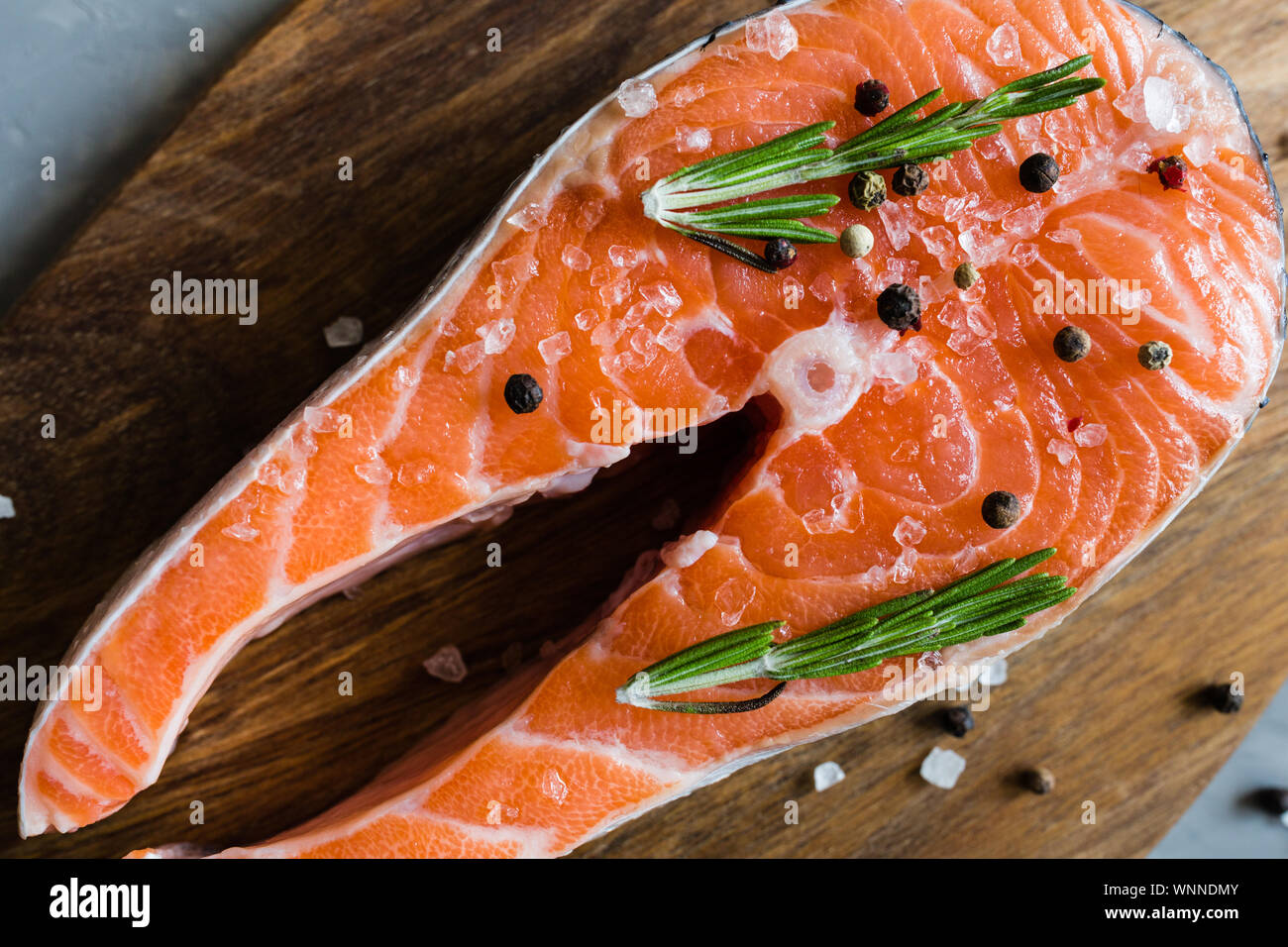 Fresh raw salmon fish steak with spices on dark stone background ...