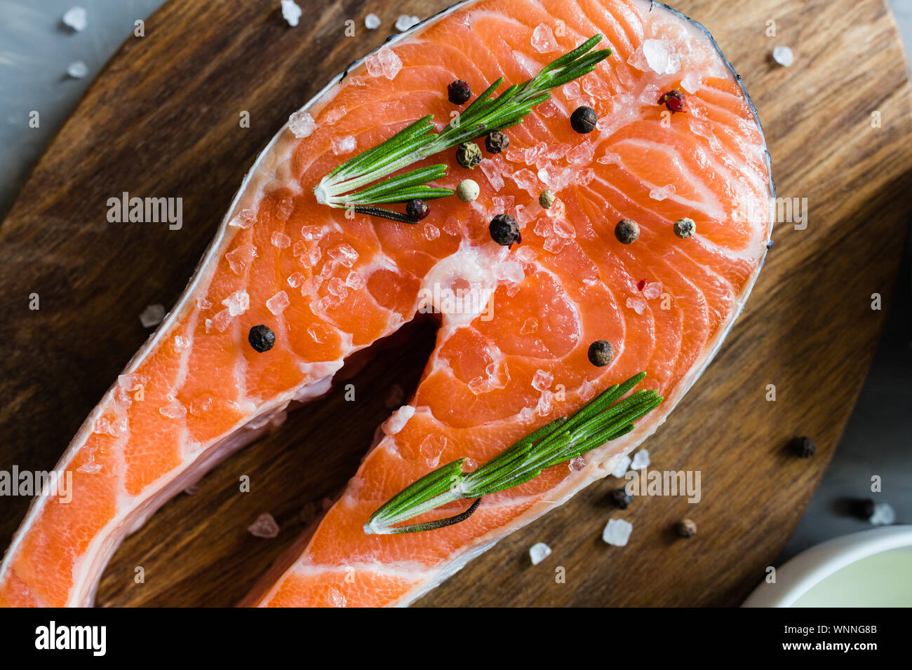 Fresh raw salmon fish steak with spices on dark stone background ...