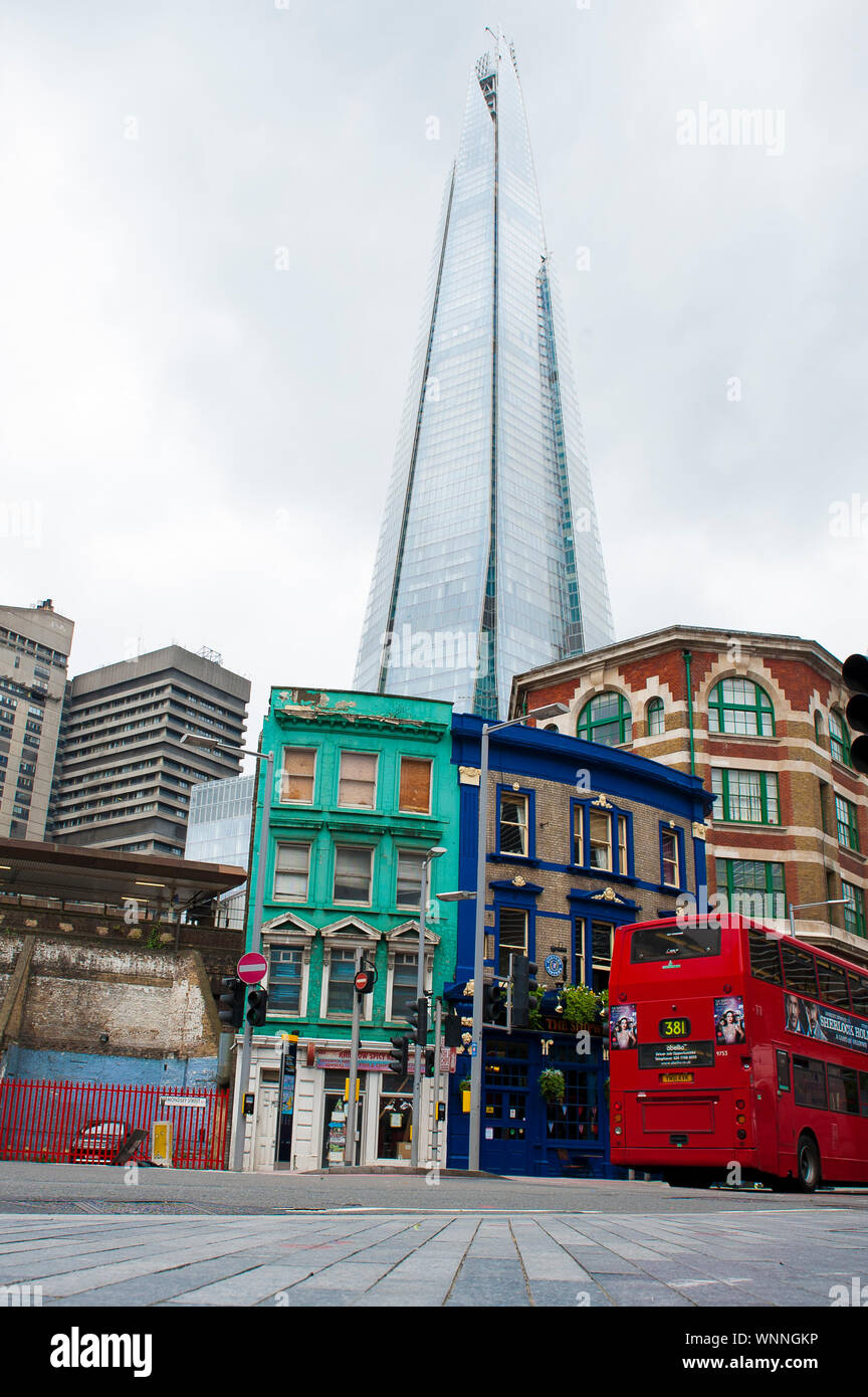 Old english pub against the modern Shard building in London, United Kingdom Stock Photo