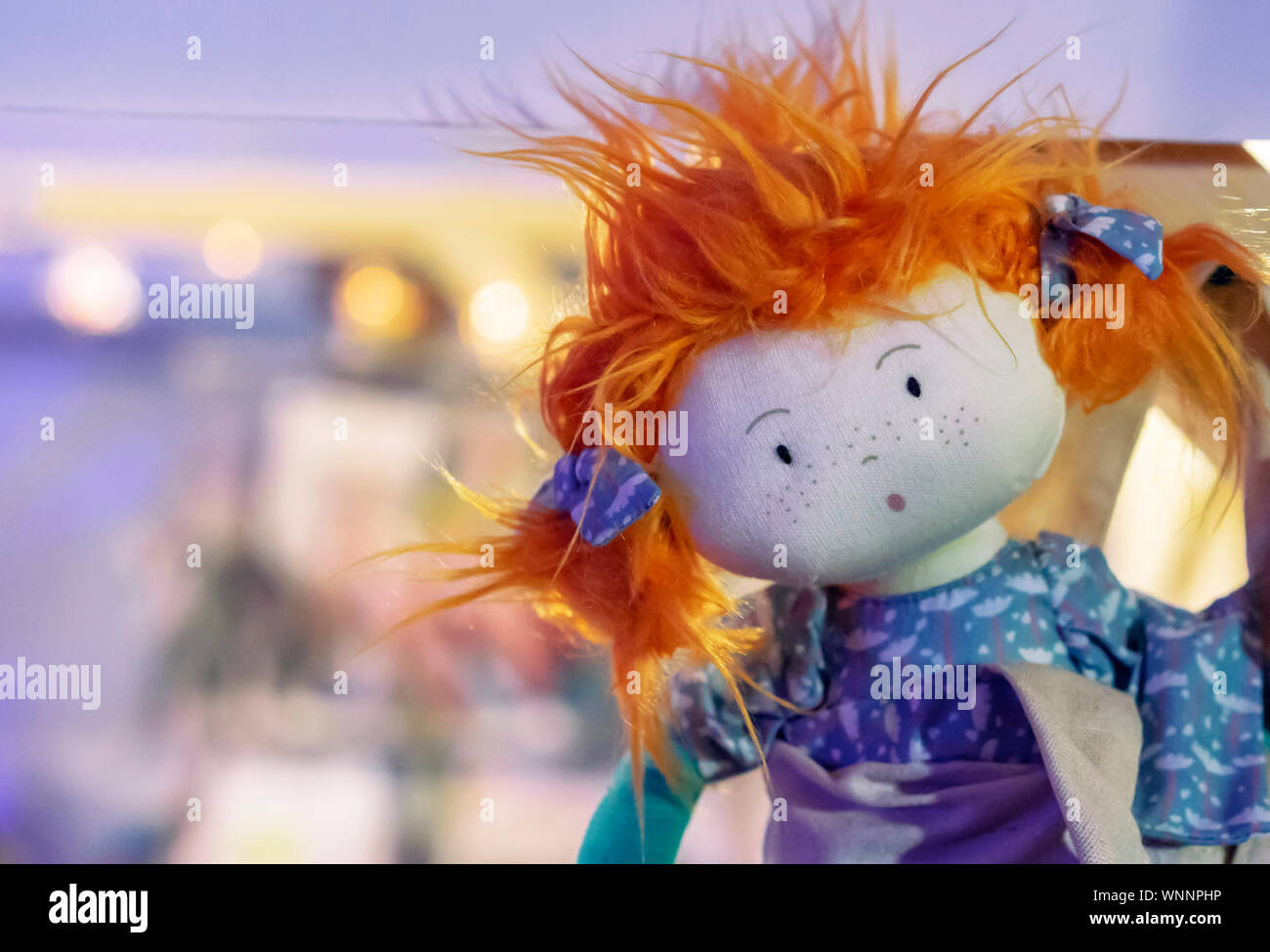 Soft Toy Doll With Red Hair And Purple Dress Stock Photo