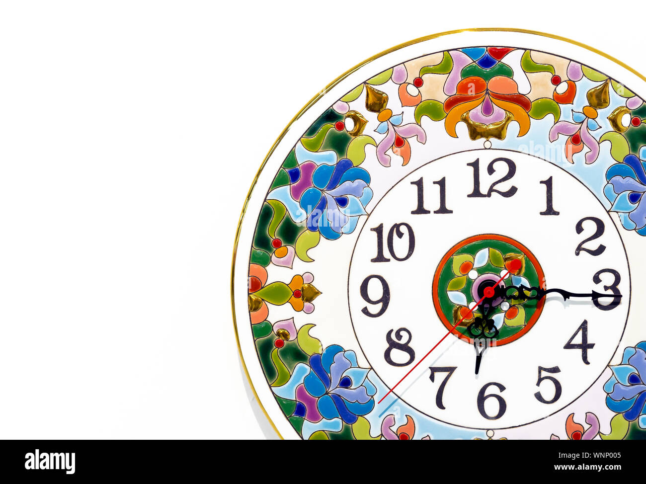 Ceramic clock with bright patterns on a white background Stock Photo