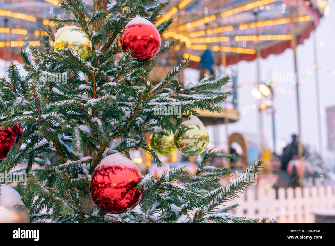 Christmas tree on the street is decorated with colorful toys on the ...