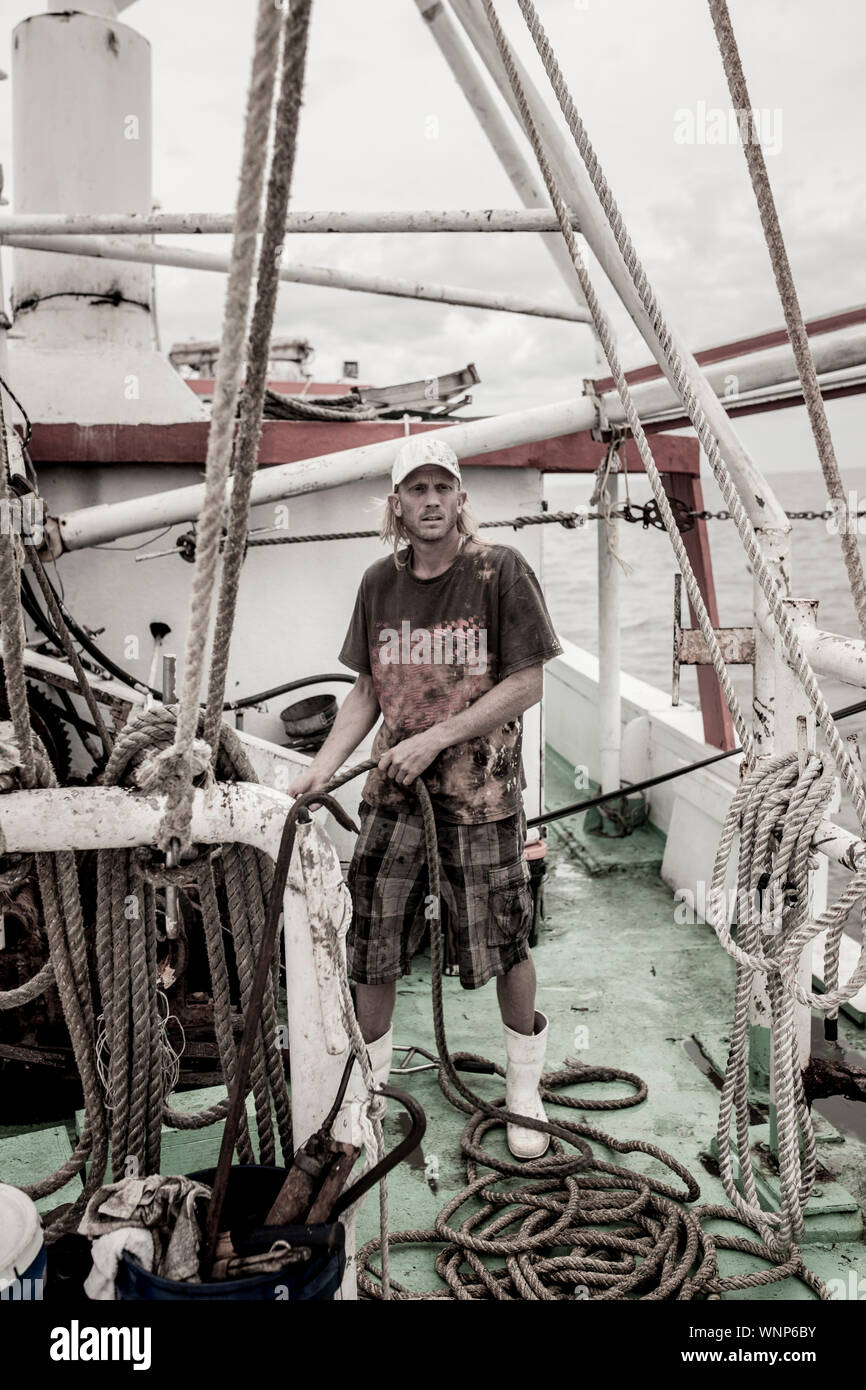 deckhand on the deck of a fishing boat Stock Photo Alamy