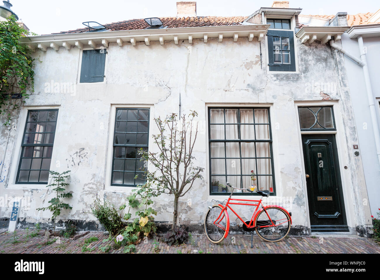 Old house with red bike Stock Photo
