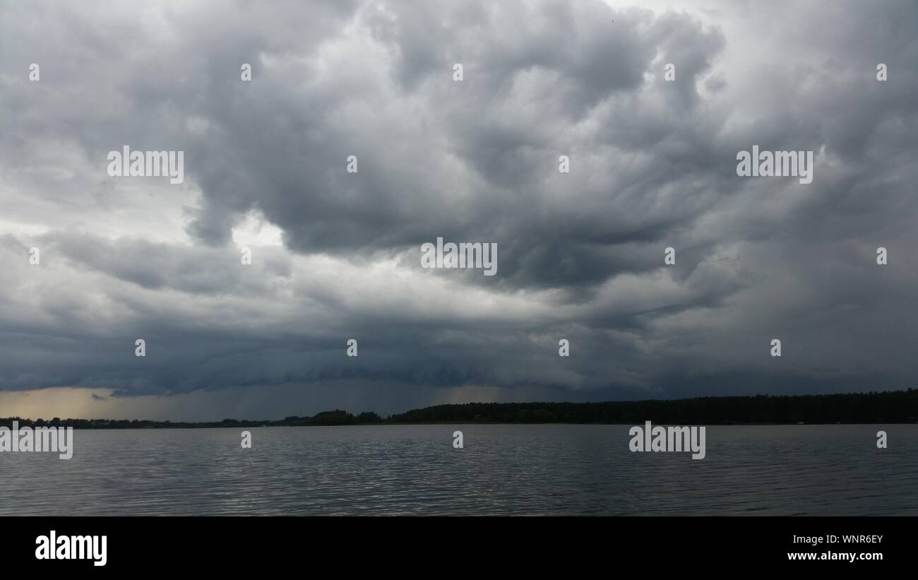 Scenic View Of Lake Against Cloudy Sky Stock Photo