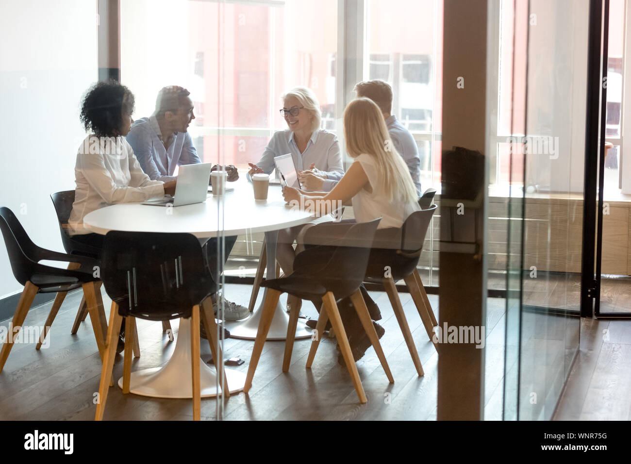 Diverse businesspeople brainstorm negotiating at office meeting Stock Photo