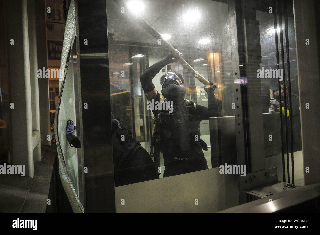 Kowloon, Hong Kong. 6th Sep, 2019. Protesters smash glass on an elevator at Yau Ma Tei Metro Station on Friday September 6, 2019 in Mong Kok Town Kowloon, Hong Kong.Thousands of protestors gathered outside of Mong Kok police station and around that area to protest the police violence against citizens of Hong Kong.Protesters Moved Nathan Rd to south, destroying surveillance cameras, street signs, building barricades with wooden panes and garbages then set on fire as they move on.9/6/2019.Kowloon, Hong Kong. Credit: ZUMA Press, Inc./Alamy Live News Stock Photo