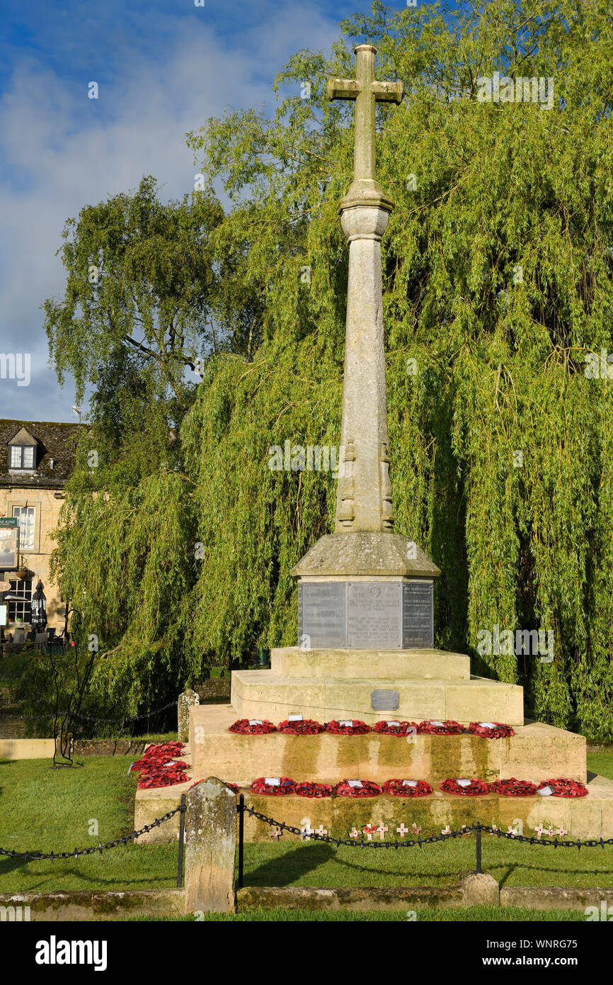 World War I and II Memorial cross on High street on the River Windrush in Bourton-on-the-Water village in the Cotswolds England Stock Photo